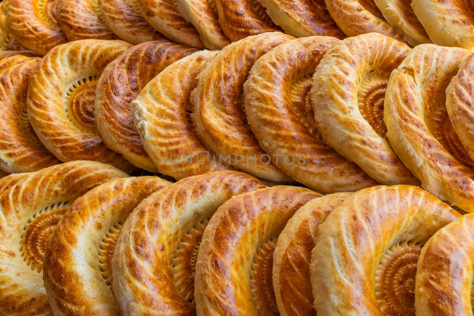 Traditional bread in Central Asia. Tandoor flatbread. Bread nan cakes. Traditional Kyrgyz bread. Full-frame closeup background.