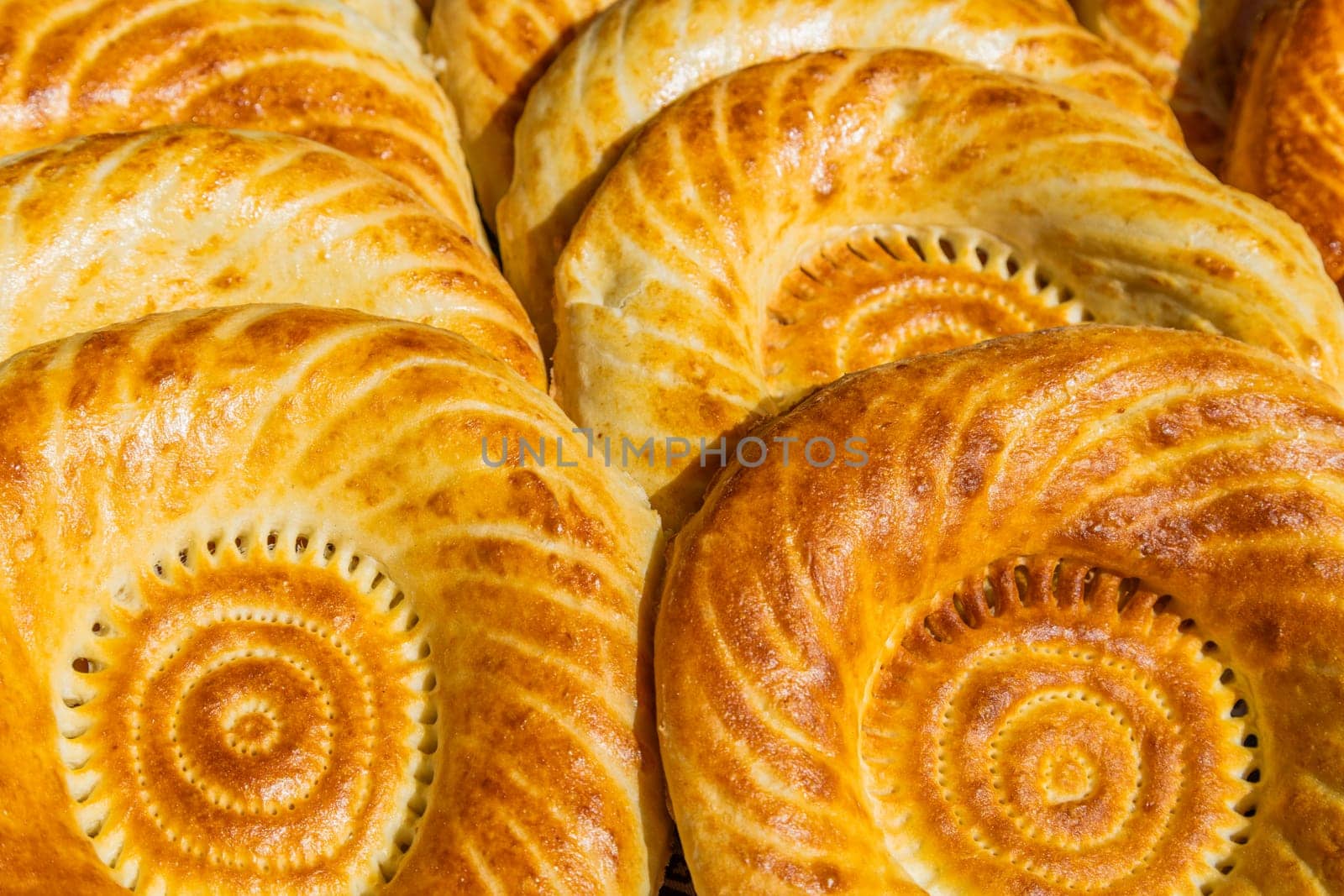 Traditional bread in Central Asia. Tandoor flatbread. Bread nan cakes. Traditional Kyrgyz bread. Full-frame closeup background.