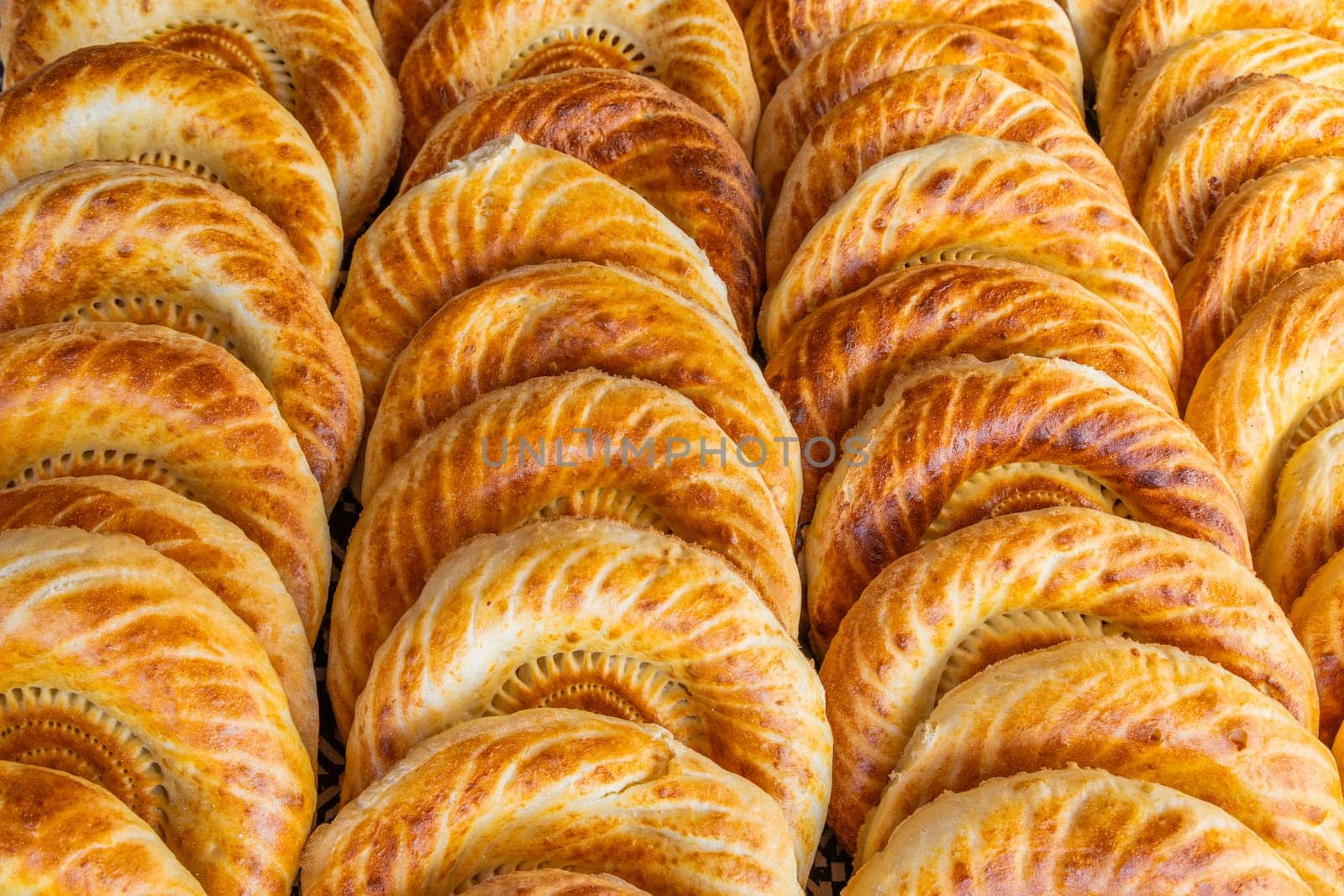 Traditional bread in Central Asia. Tandoor flatbread. Bread nan cakes. Traditional Kyrgyz bread. Full-frame closeup background.