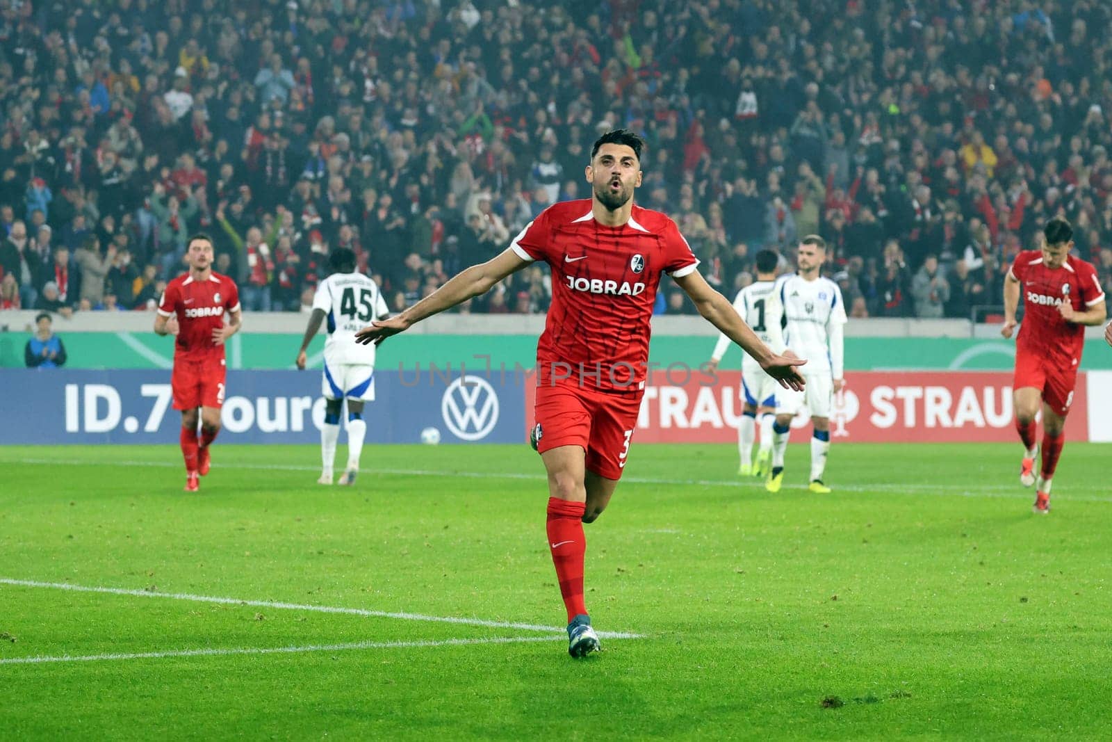 Vincenzo Grifo (SC Freiburg) scores from the penalty spot to make it 2-0 at half-time and celebrates his goal with his teammates in the 2024-25 DFB-Pokal match,2nd round: SC Freiburg vs Hamburger SV