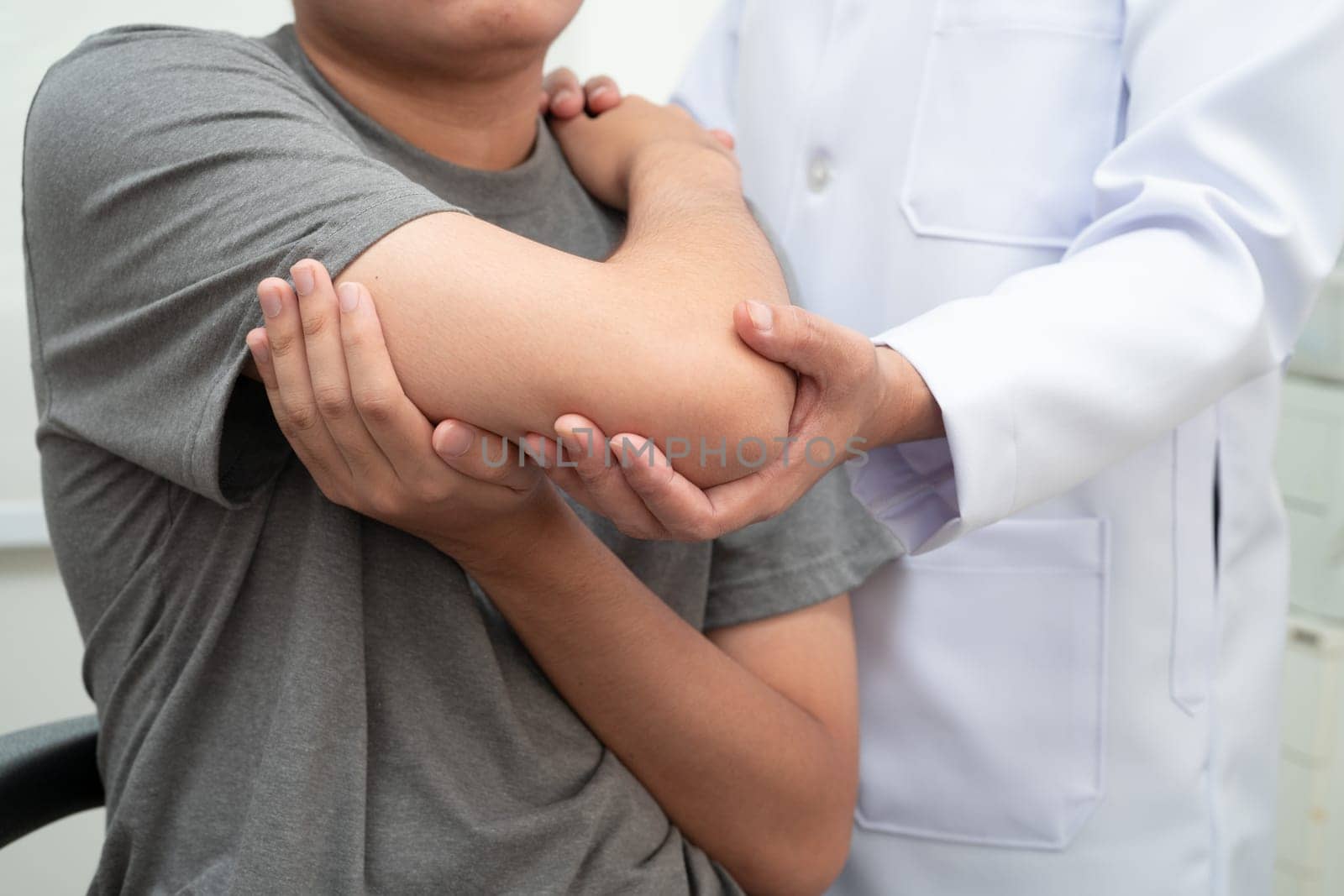 Physical therapy, Asian therapist doctor treat perform pain young man in hospital.