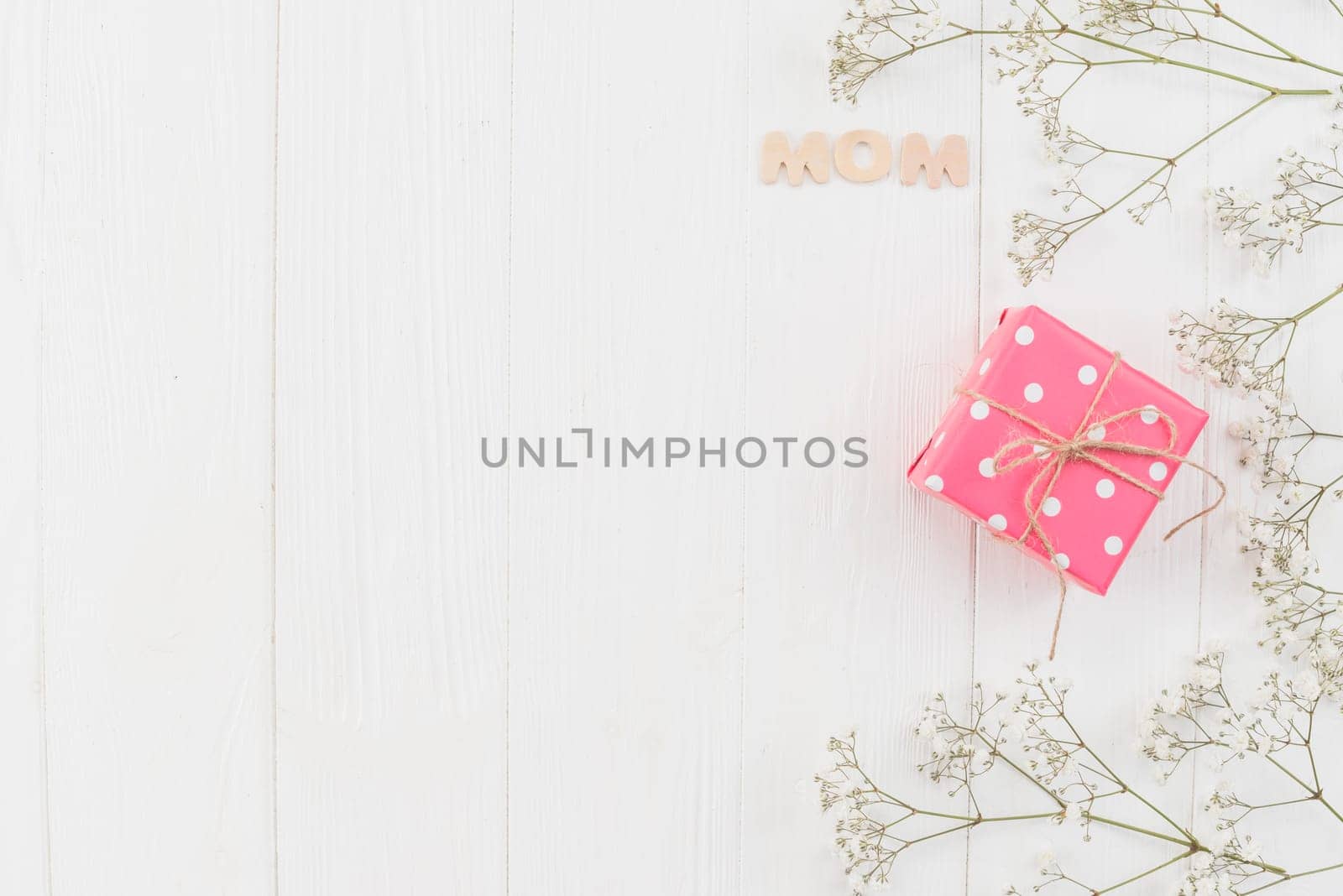 word mom with gift box flowers. High resolution photo