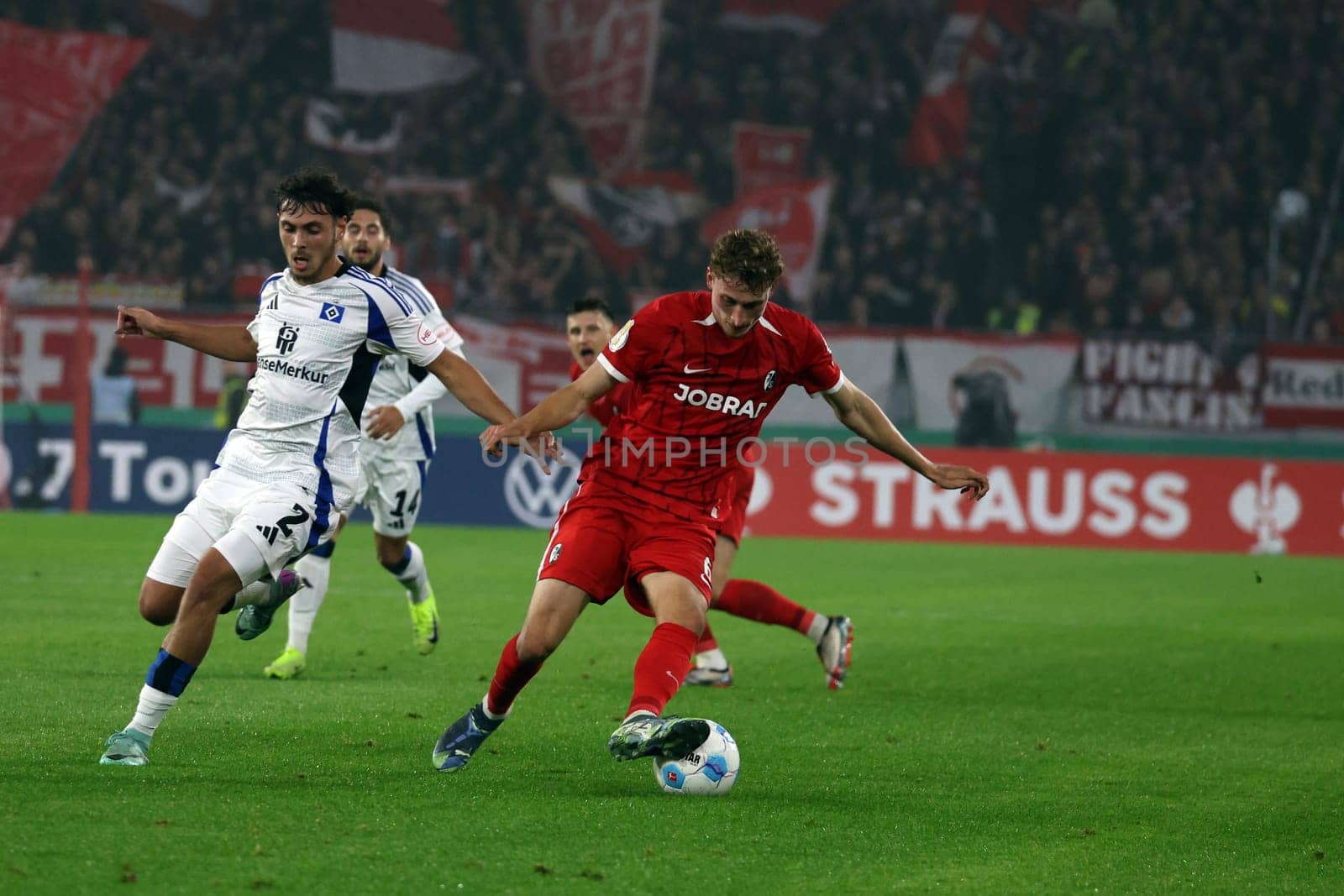 Patrick Osterhage (SC Freiburg) pulls past his opponent William Mikelbrencis (Hamburger SV / HSV) with a step-over in the match for the DFB-Pokal 2024-25,2nd round: SC Freiburg vs Hamburger SV