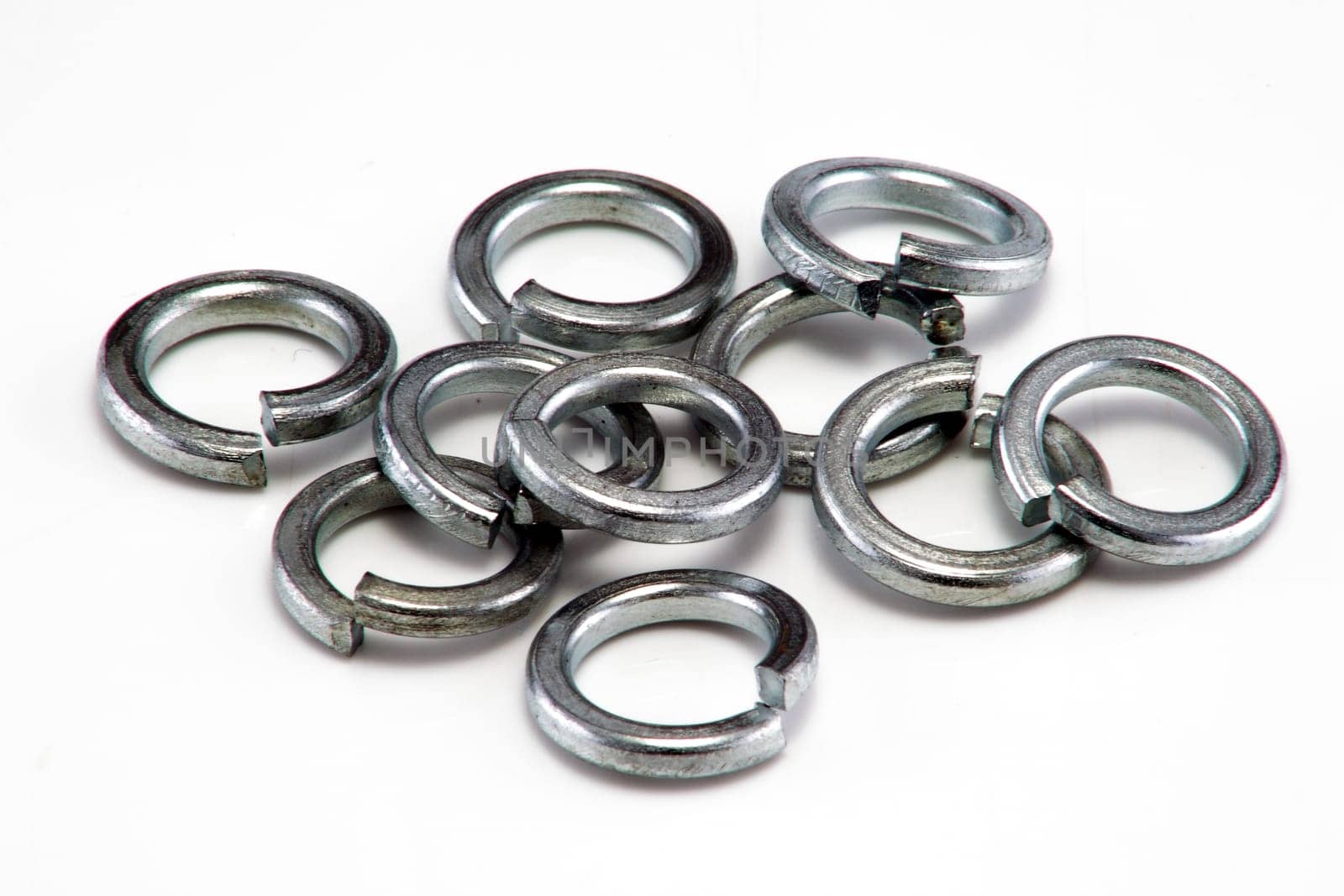 A heap of large split spring washers on white background