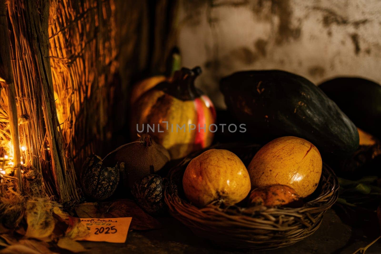 A cozy arrangement of pumpkins and gourds provides a warm autumn atmosphere in a rustic setting with soft lighting.