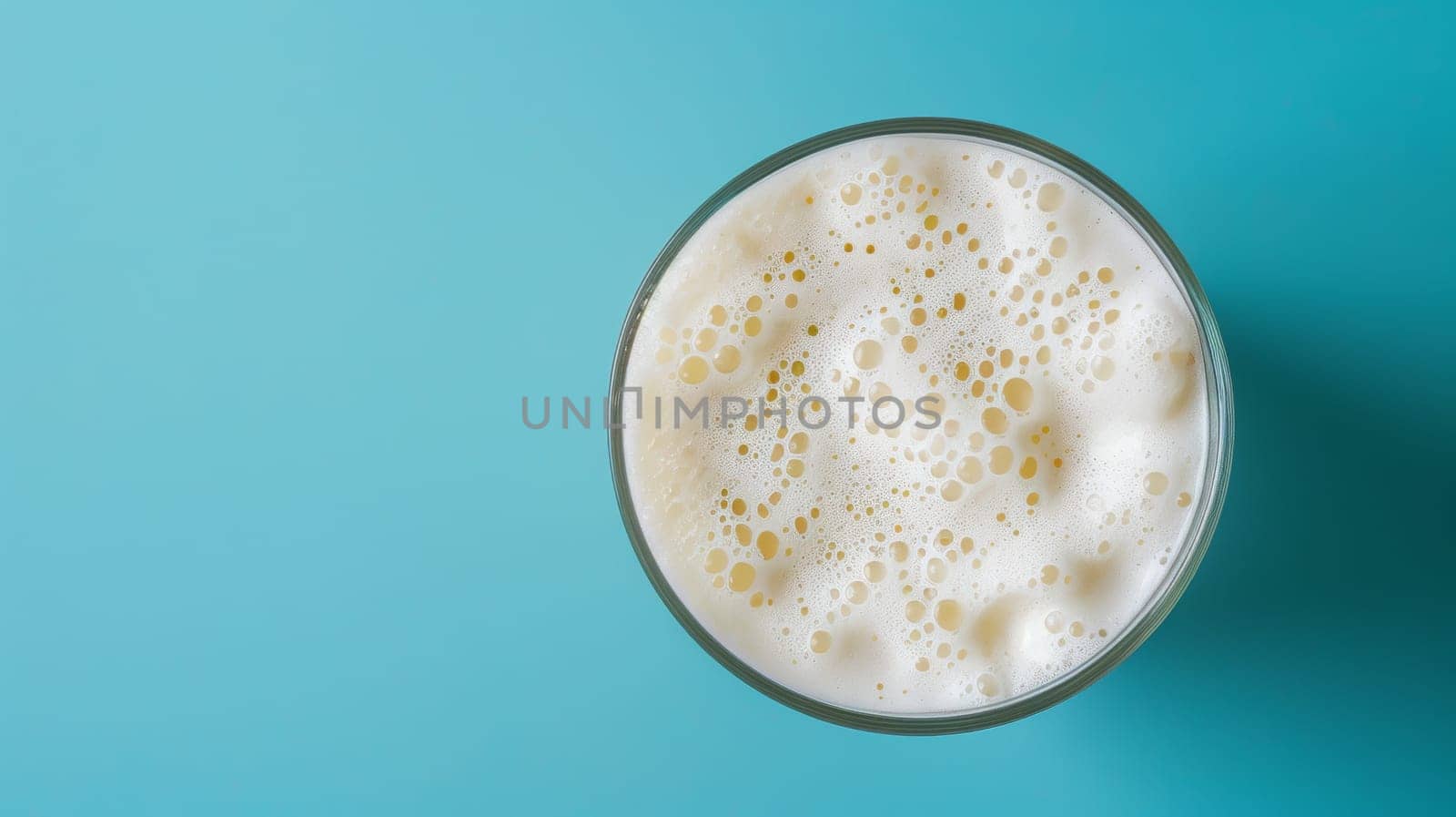 Top-down shot of a spinning glass of milkshake with room for text