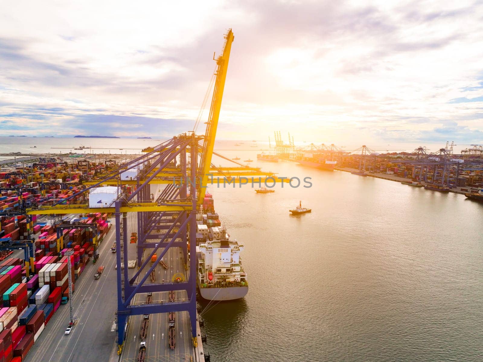Logistics and transportation of container cargo ship at ship port. Container truck and crane bridge in shipyard. Import export and transport industry. Terminal port for export transport by ship.