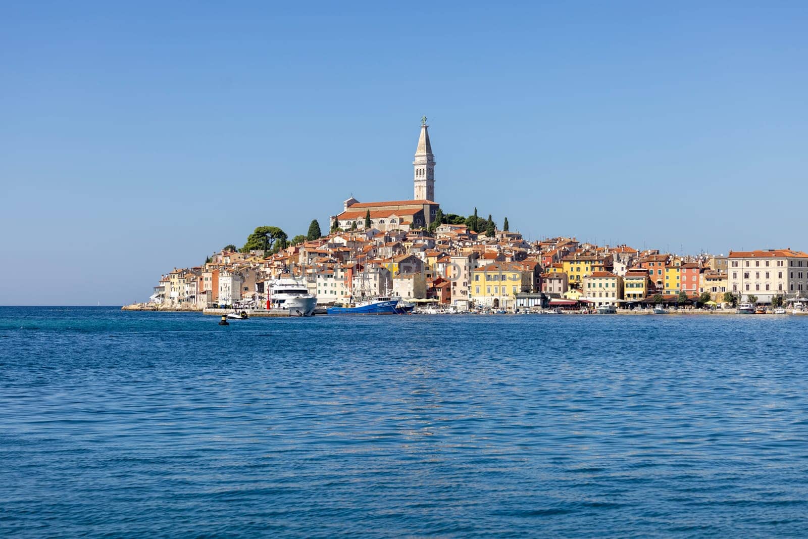 Rovinj, Croatia, Istria - September 29, 2023: Beautiful view from the South port Rovinj over Adriatic Sea to the peninsula with the Old Town and the tower of Saint Euphemia Church