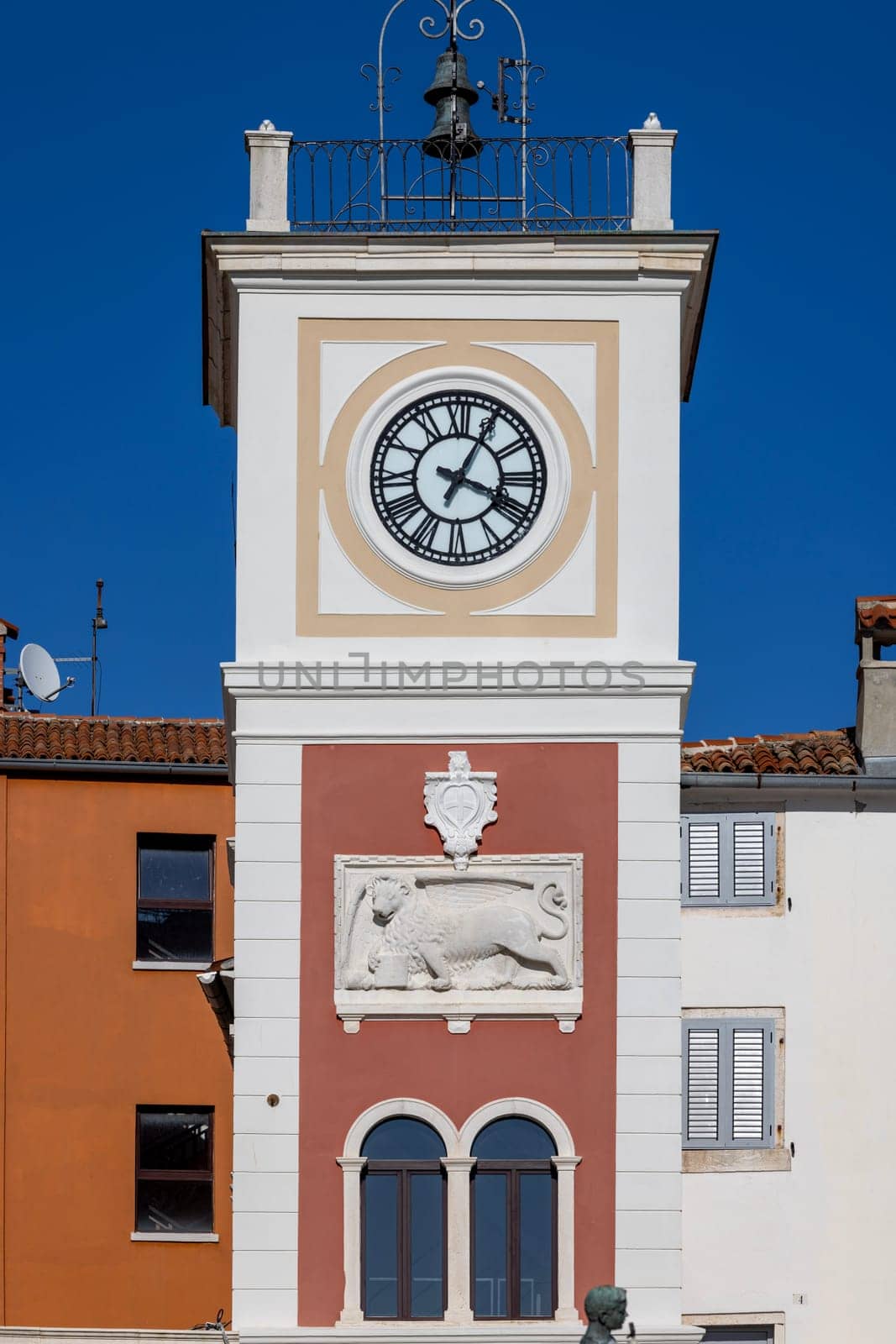 Rovinj, Croatia, Istria - September 29, 2023: Tower with city clock and relief of Venetian lion located on Marshal Tito Square
