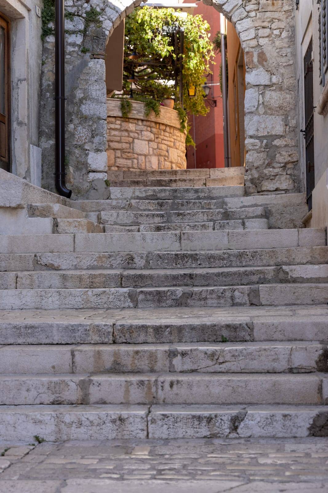 Rovinj, Croatia, Istria - September 29, 2023: Medieval Gate of the Holy Cross with stone stairs, one of the remaining gateways in the Old Town