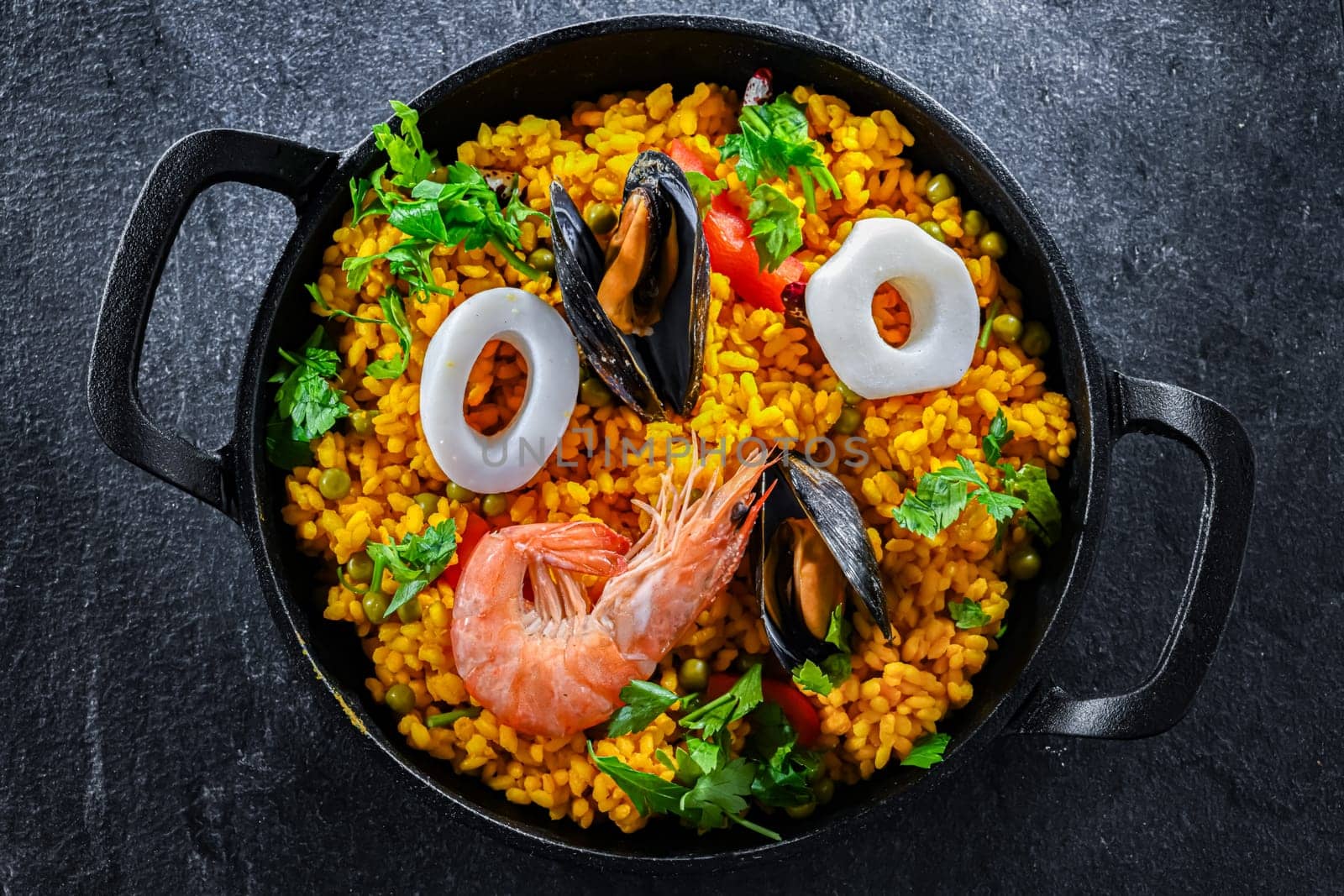 Seafood paella served in a cast iron pan.