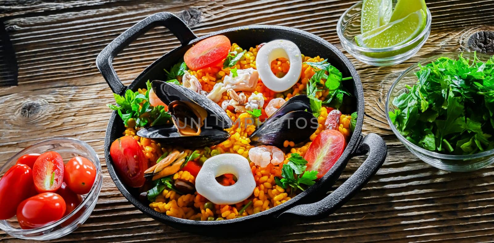 Seafood paella served in a cast iron pan.