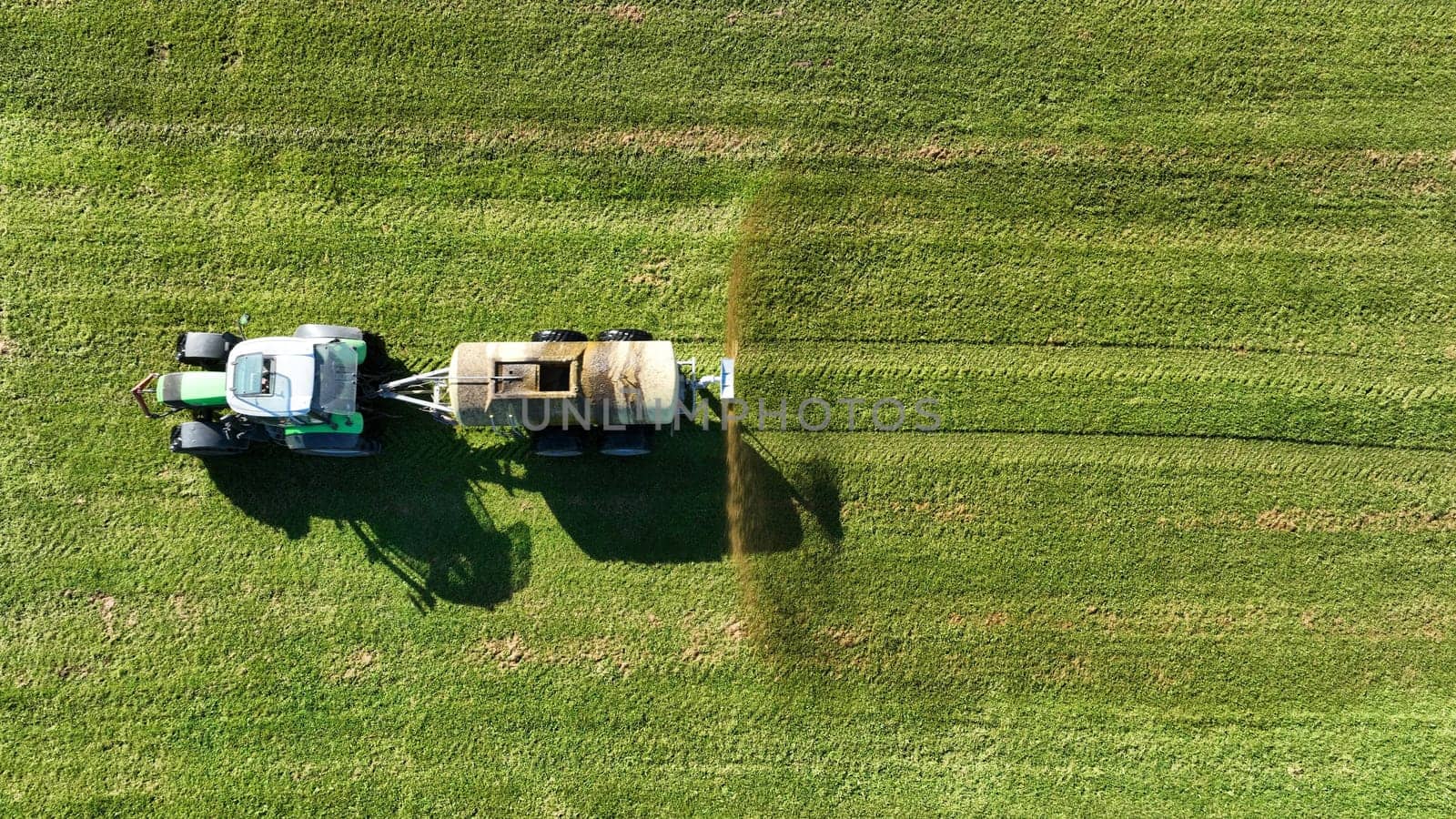Drone image of a tractor spreading liquid manure or slurry on a field