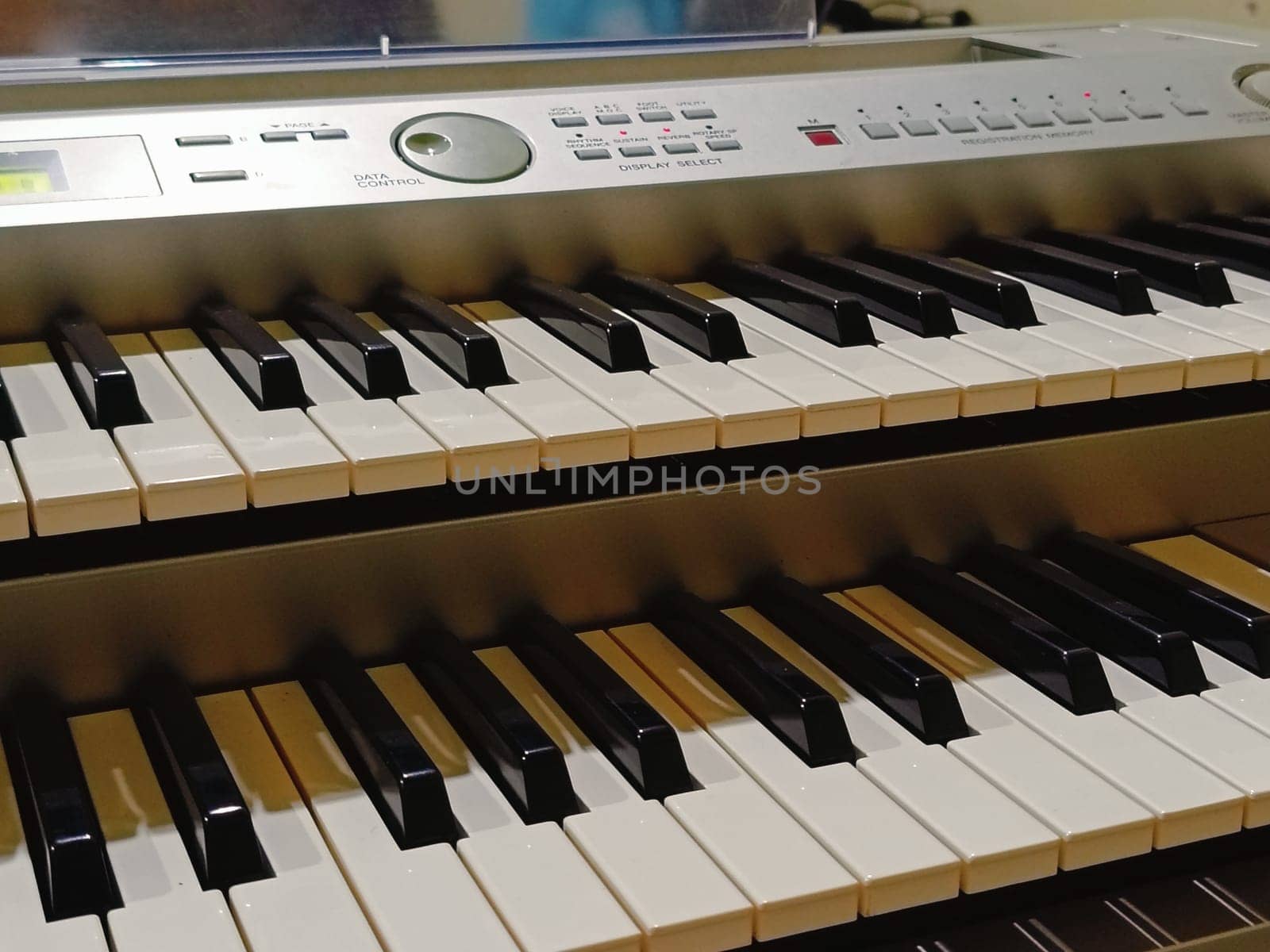 Close-up of an electronic organ in a cozy music room.