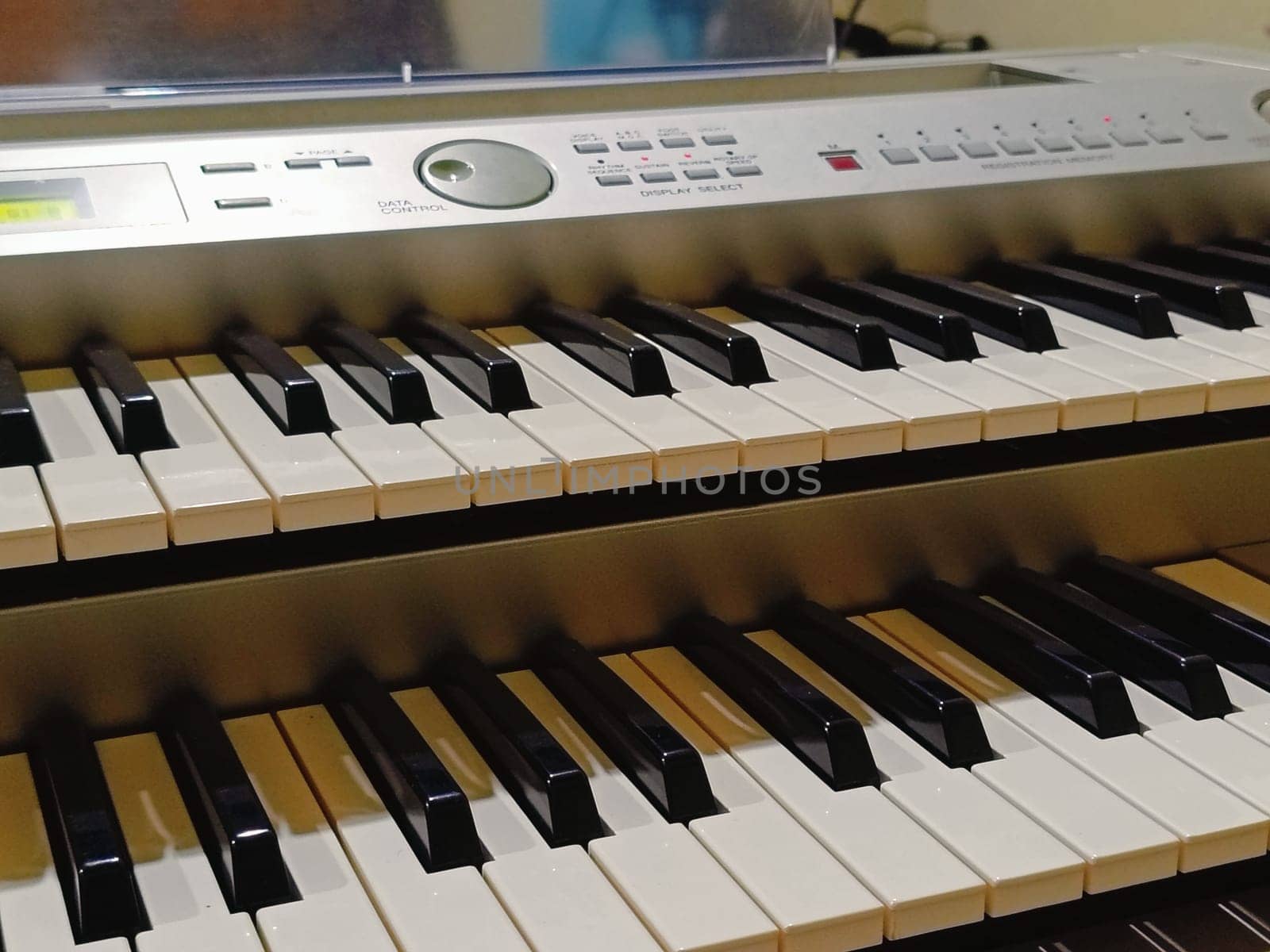 Close-up of an electronic organ in a cozy music room.