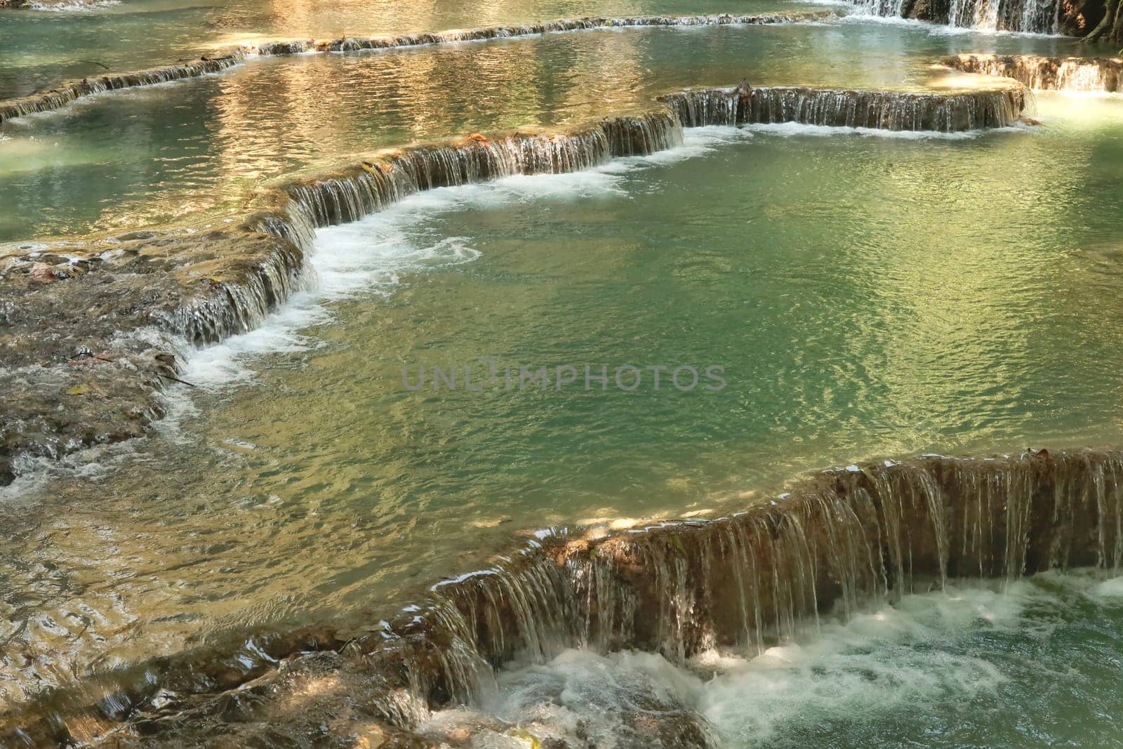 View onto the many pools, lagoons of the Kuang Si Falls, Waterfalls with its bright green water, Luang Prabang, Laos 2023