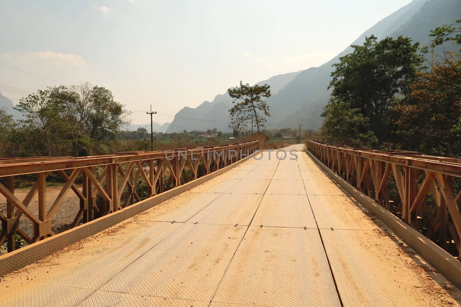 Metal bridge in the rural, remote landscape that surrounds Vang Vieng, Laos 2023