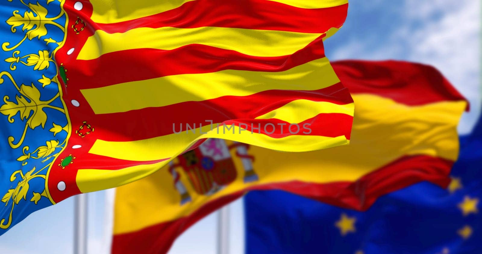 Flags of Valencian Community, Spain and the European Union waving on a clear day. Autonomous community of Spain. 3d illustration render. Selective focus. Close-up. Fluttering fabric