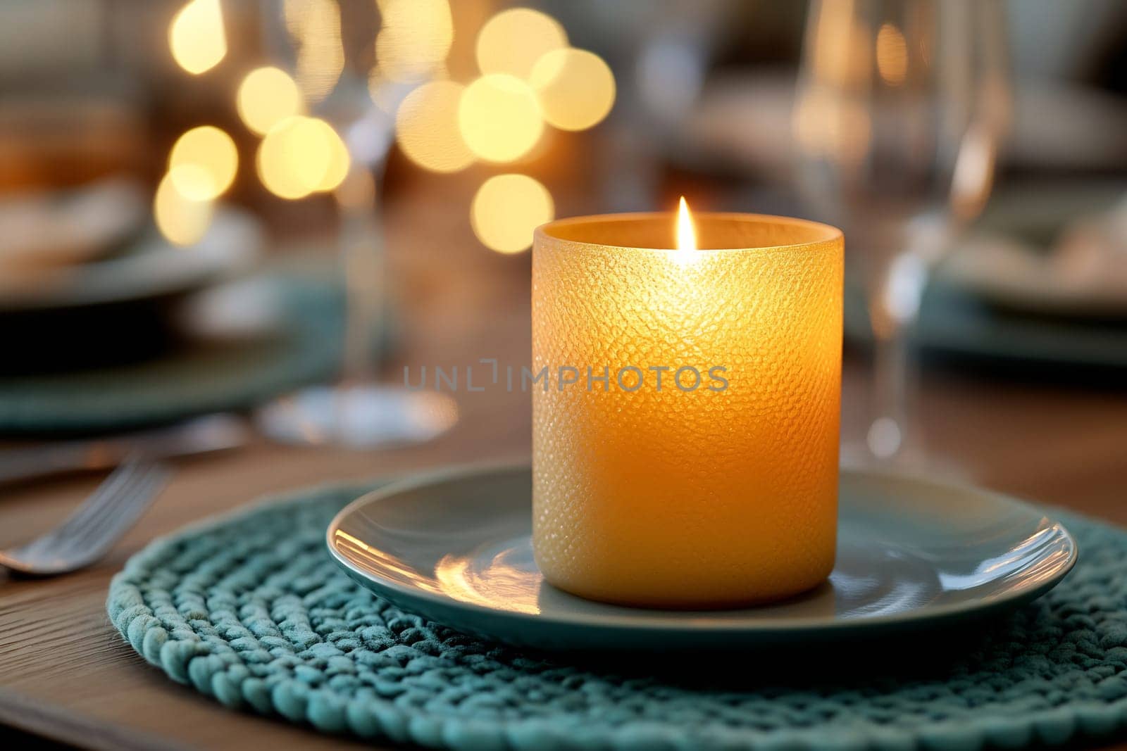 A warm candle flickers at the center of a beautifully set dinner table, creating a cozy and inviting atmosphere for a gathering.