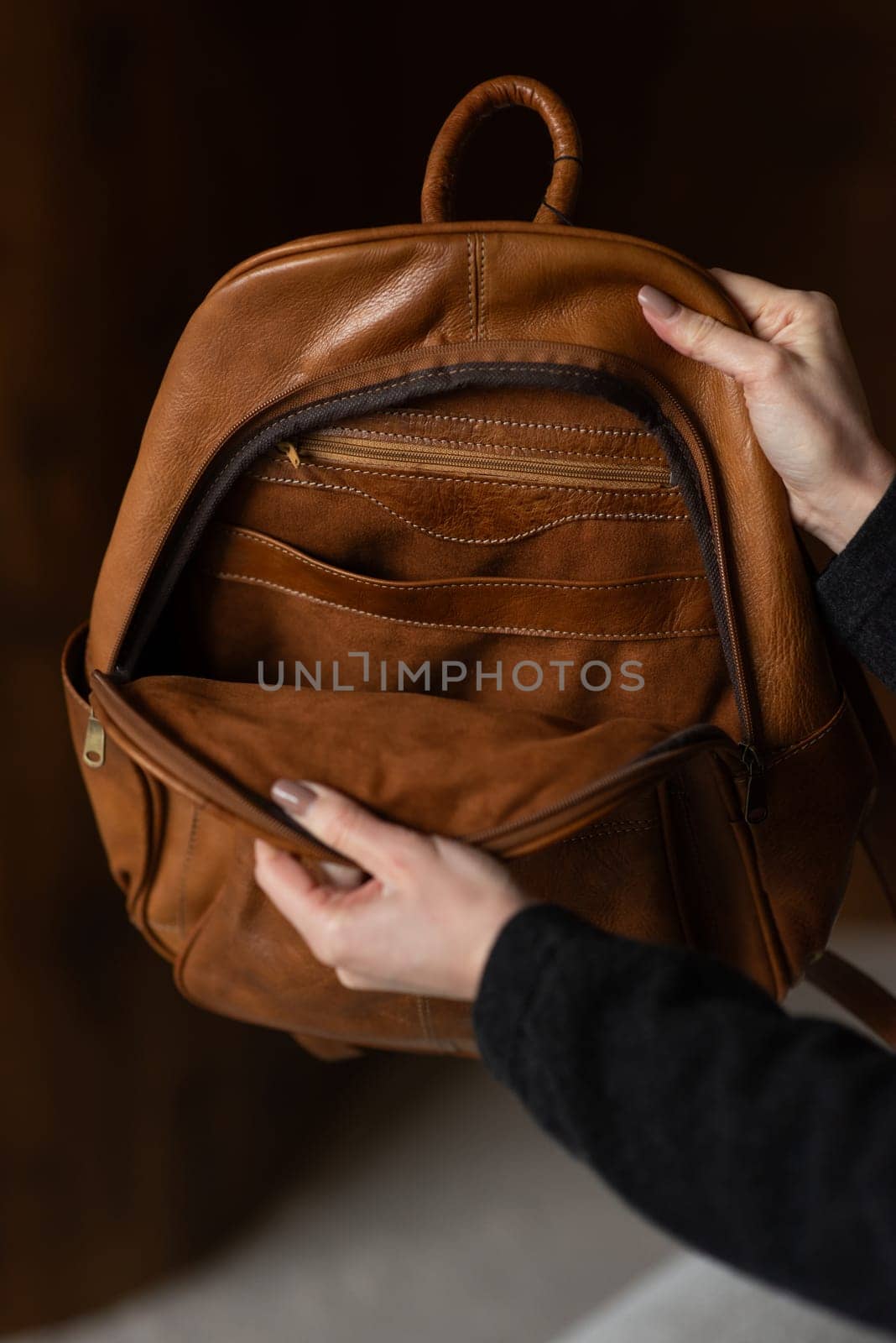 photo of a brown leather backpack with retro look. indoors photo