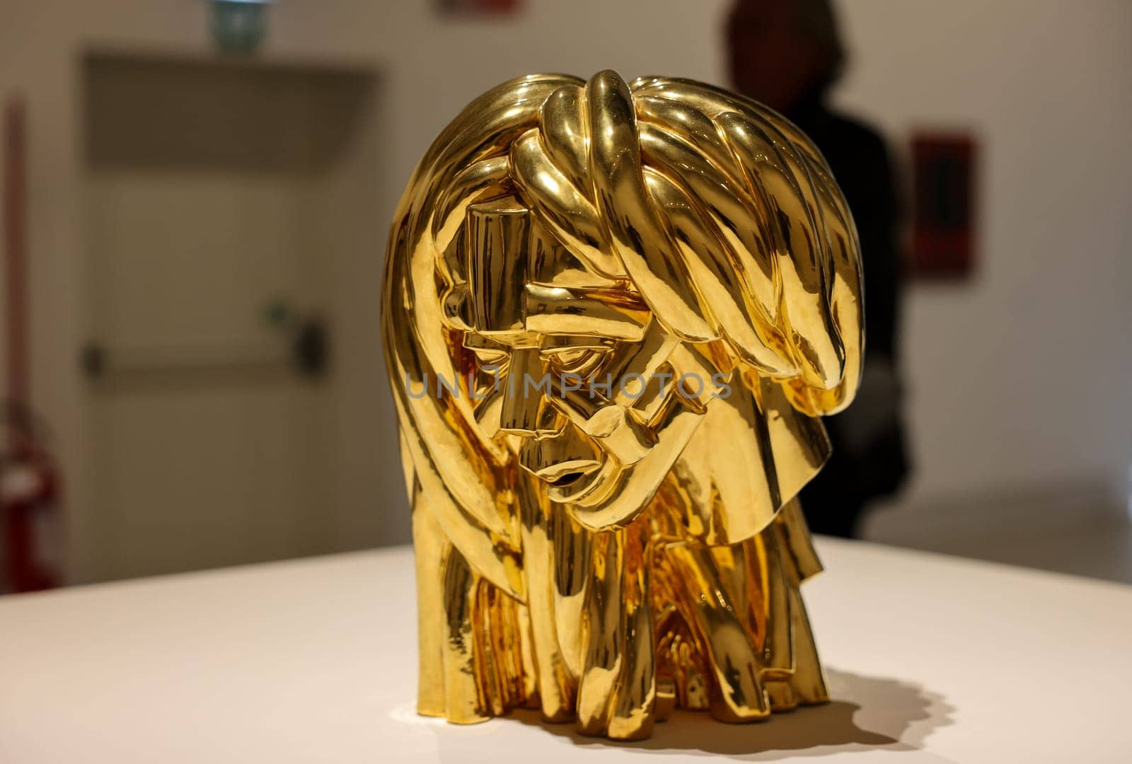 Venice, Italy - May 7 2024: Foreigners Everywhere 60th Venice Art Biennale in Venice. Malinconia by Victor Fotso Nyie. Glazed ceremic and gold.