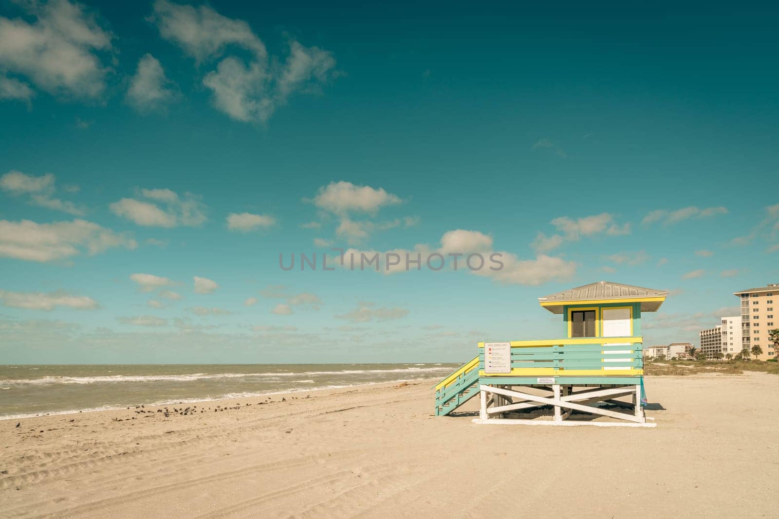 Scenic view of а beach in Venice, FL with а lifeguard booth in the foreground