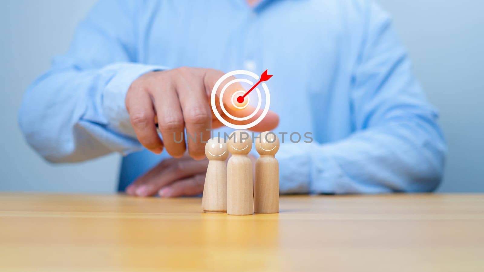 Business achievement goal and objective target, Team growing business success concept, Teamwork, Successful team, Hand holding dartboards target and human icon with line connection on wooden block.