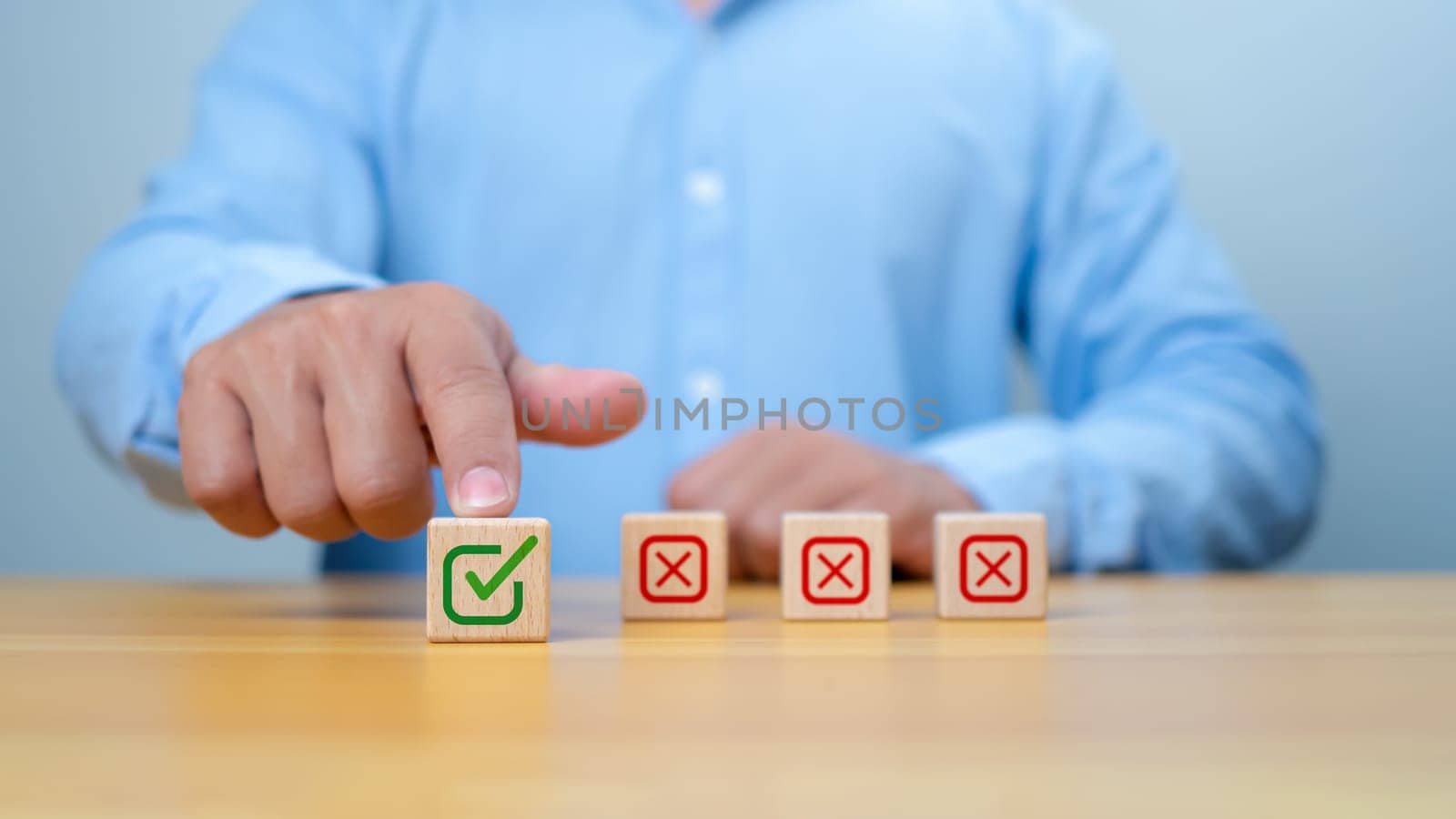 Businessman select green correct sign mark print on wooden block for approve business project proposal concept. Goals achievement and business success. Task completion. Ethical corporate.
