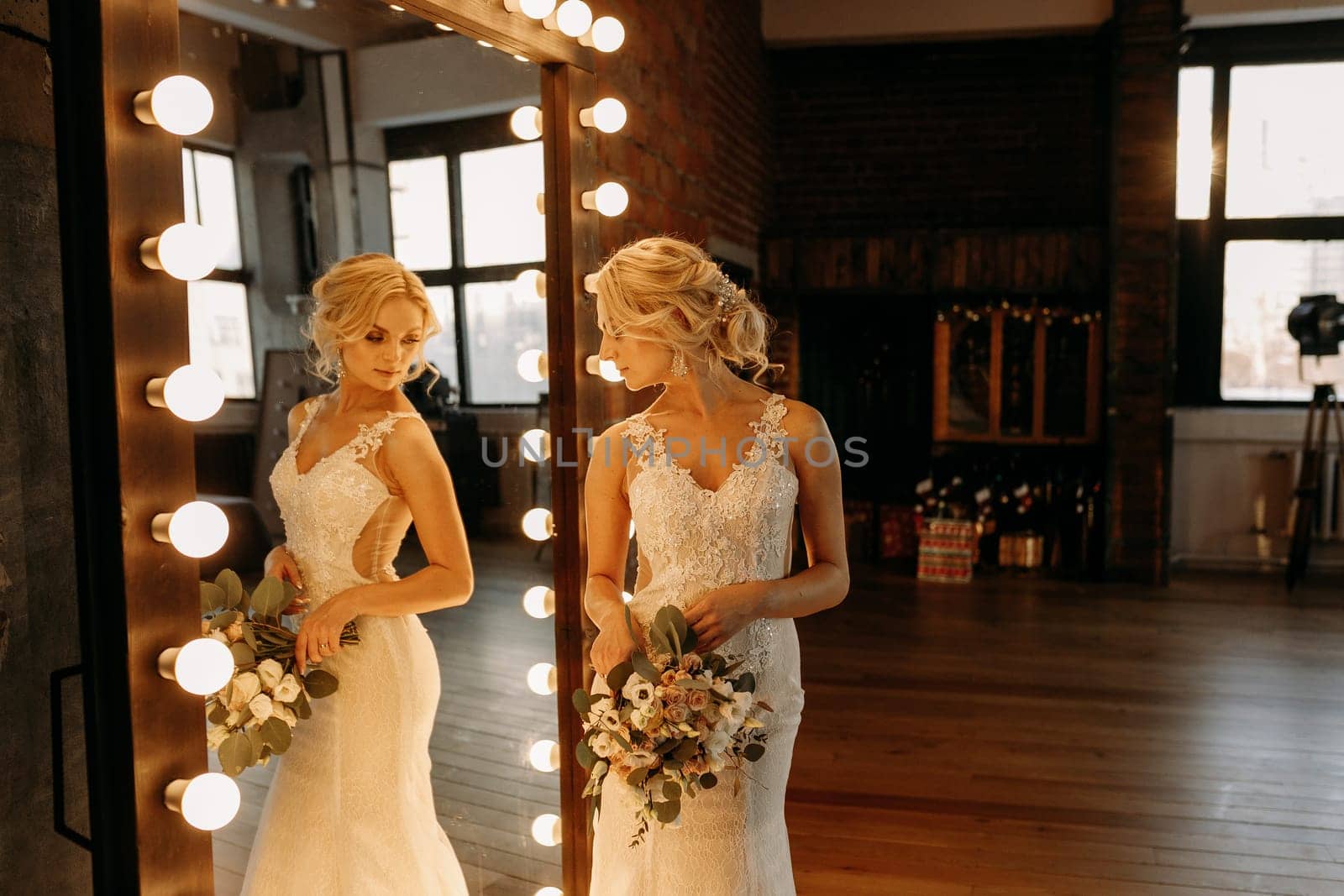 A bride admires her stunning reflection in an elegant vintage mirror before her joyful wedding celebration