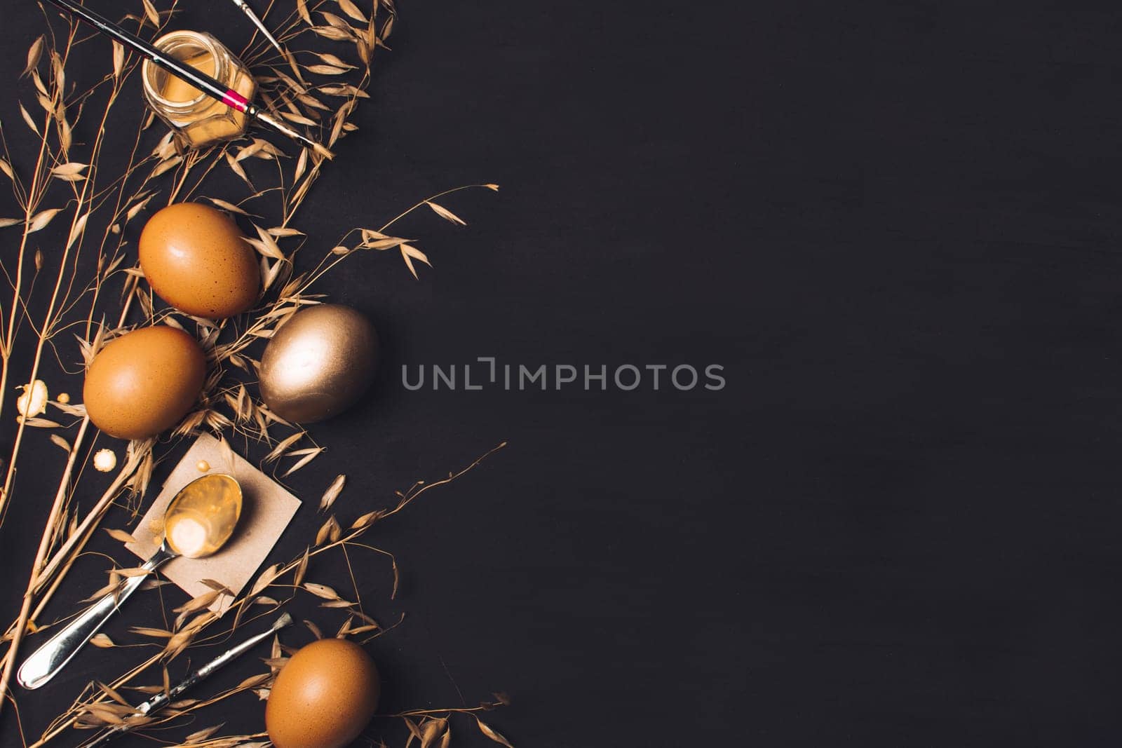 easter eggs near spoon paper brush dye can dry grass. High resolution photo