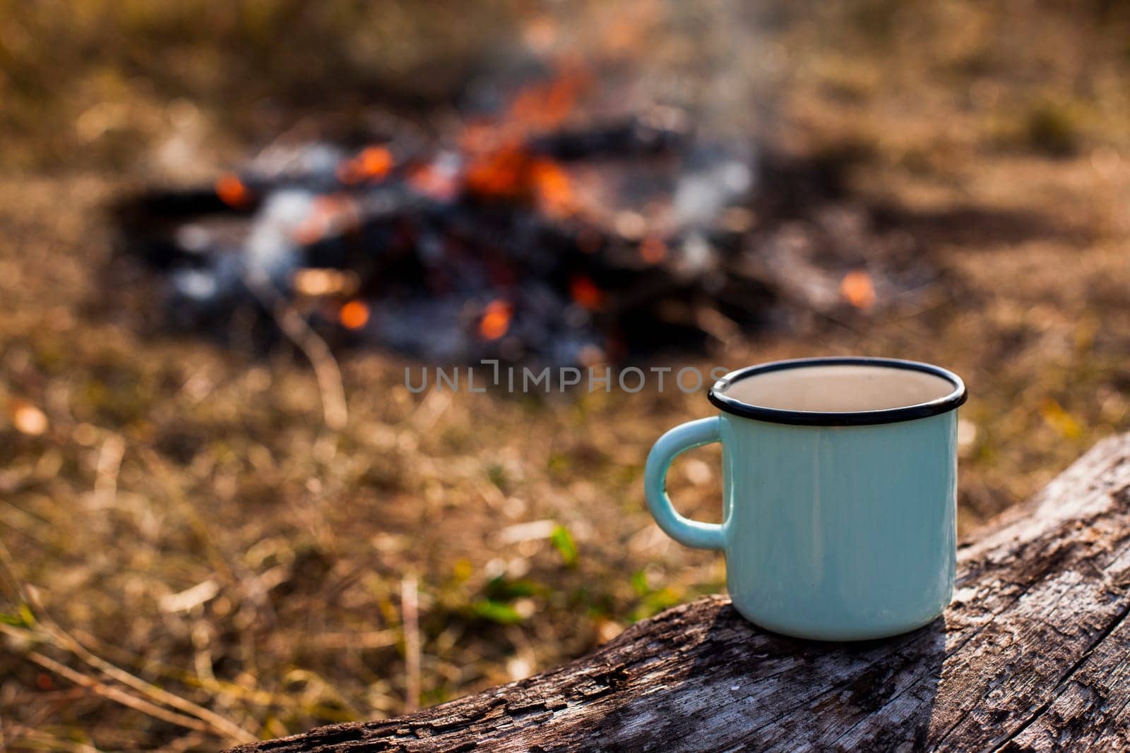 focused blue cup coffee burned out campfire. High resolution photo