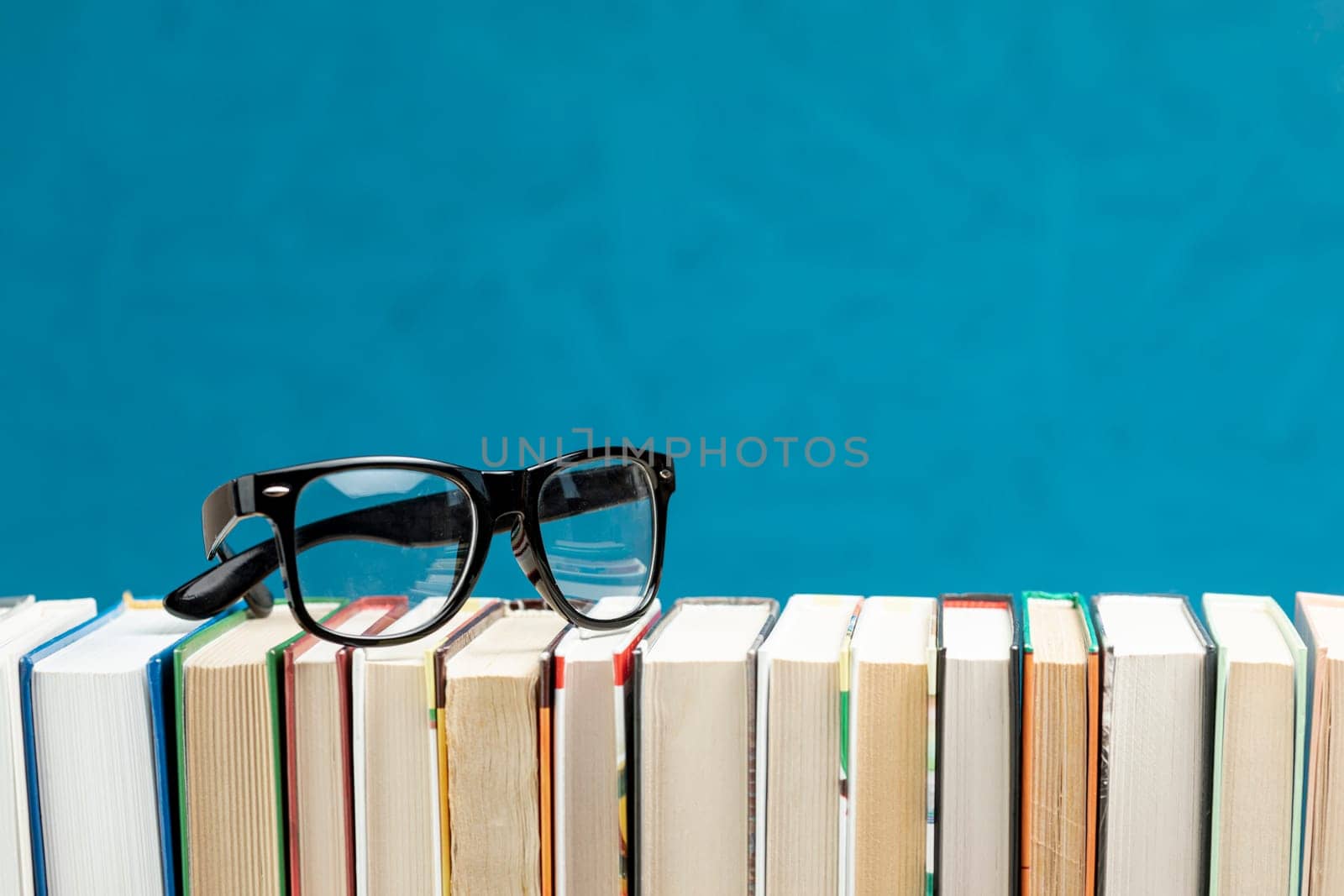 front view books with glasses. High resolution photo