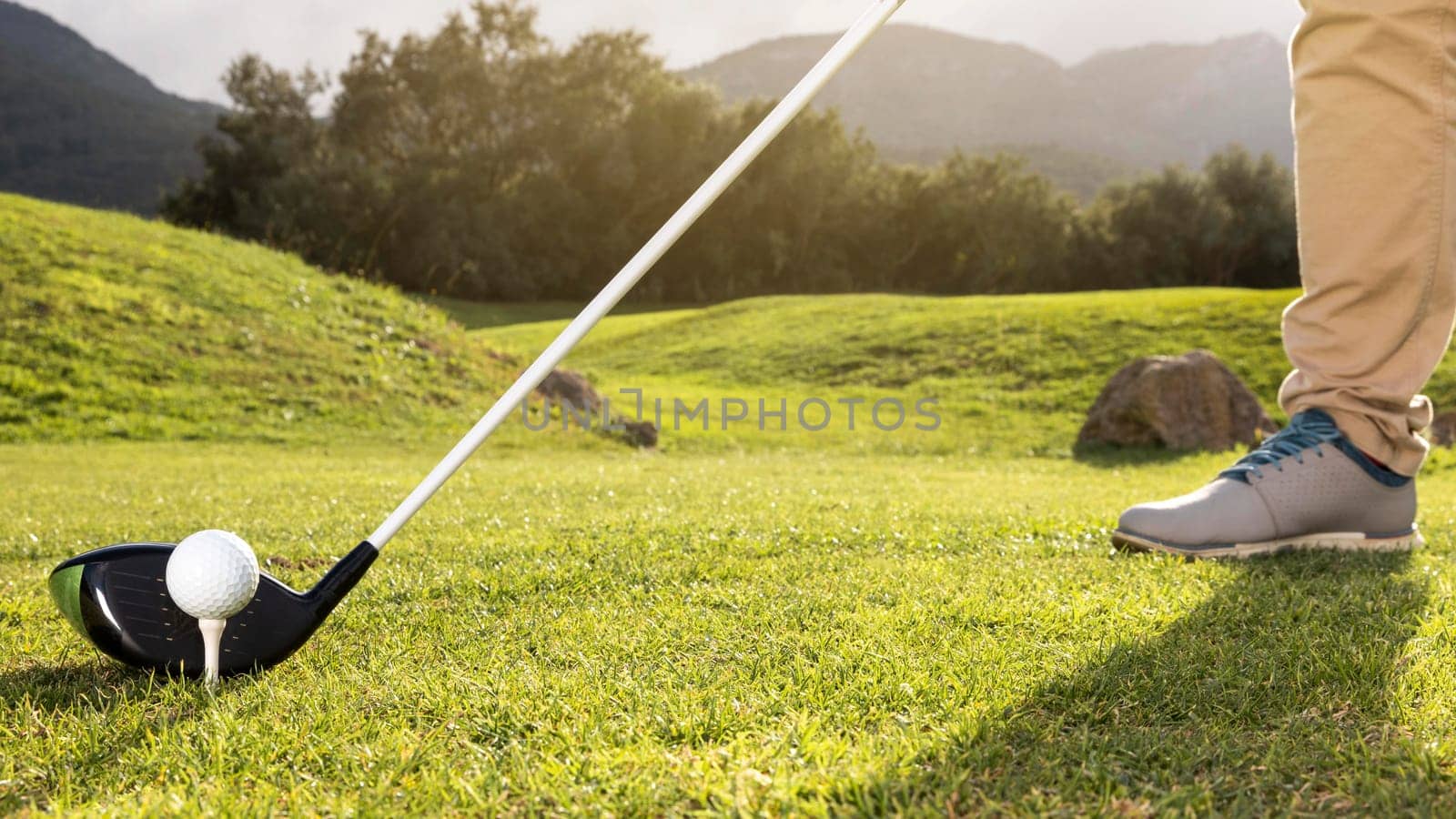 man practicing golf field. High resolution photo