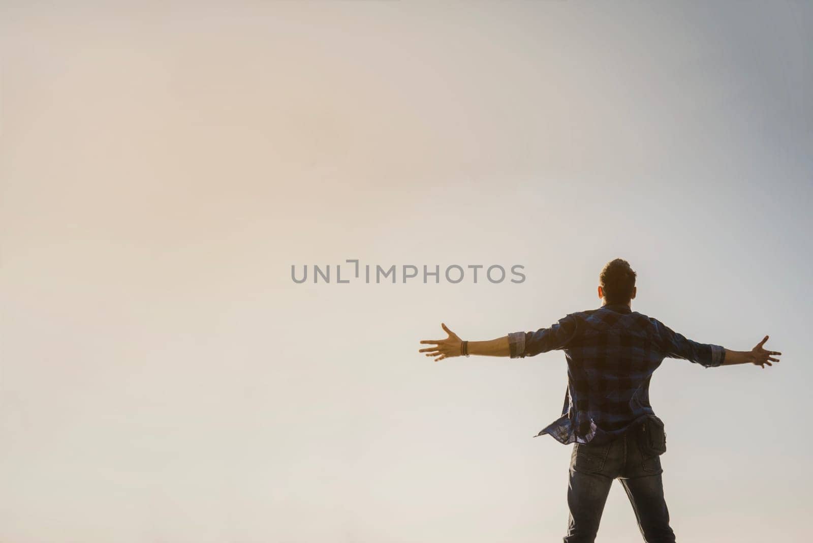 man with open arms looking sky. High resolution photo