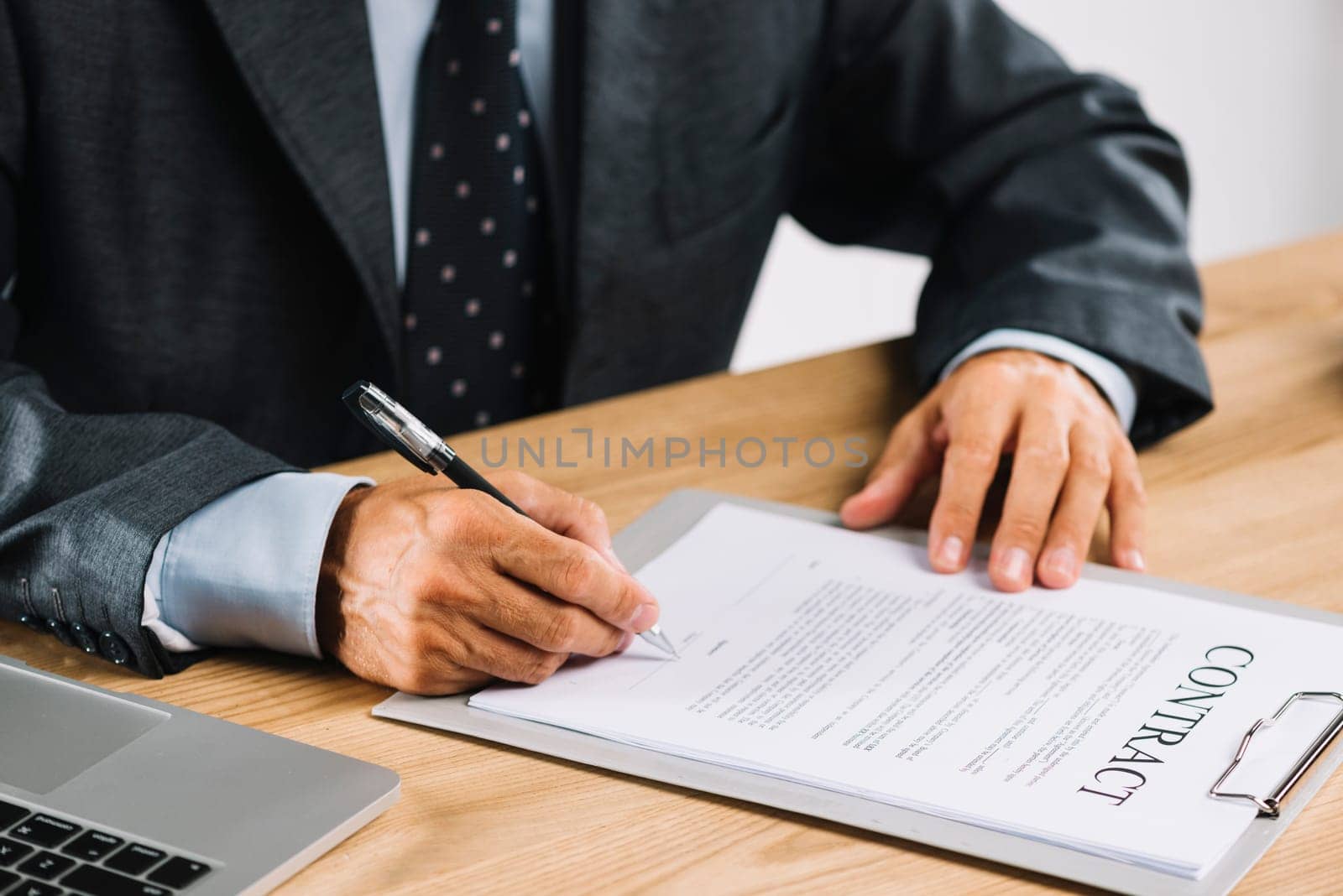 male lawyer signing contract with pen clipboard. High resolution photo