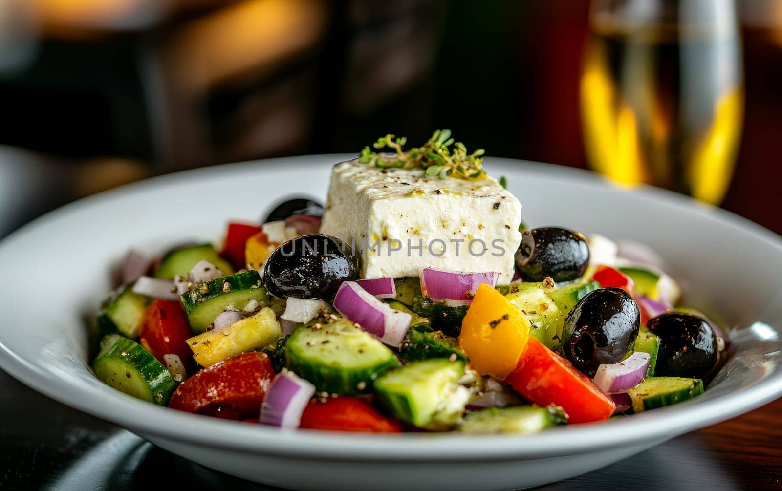 A classic Greek salad with fresh vegetables, olives, and a generous serving of feta cheese, drizzled with olive oil.