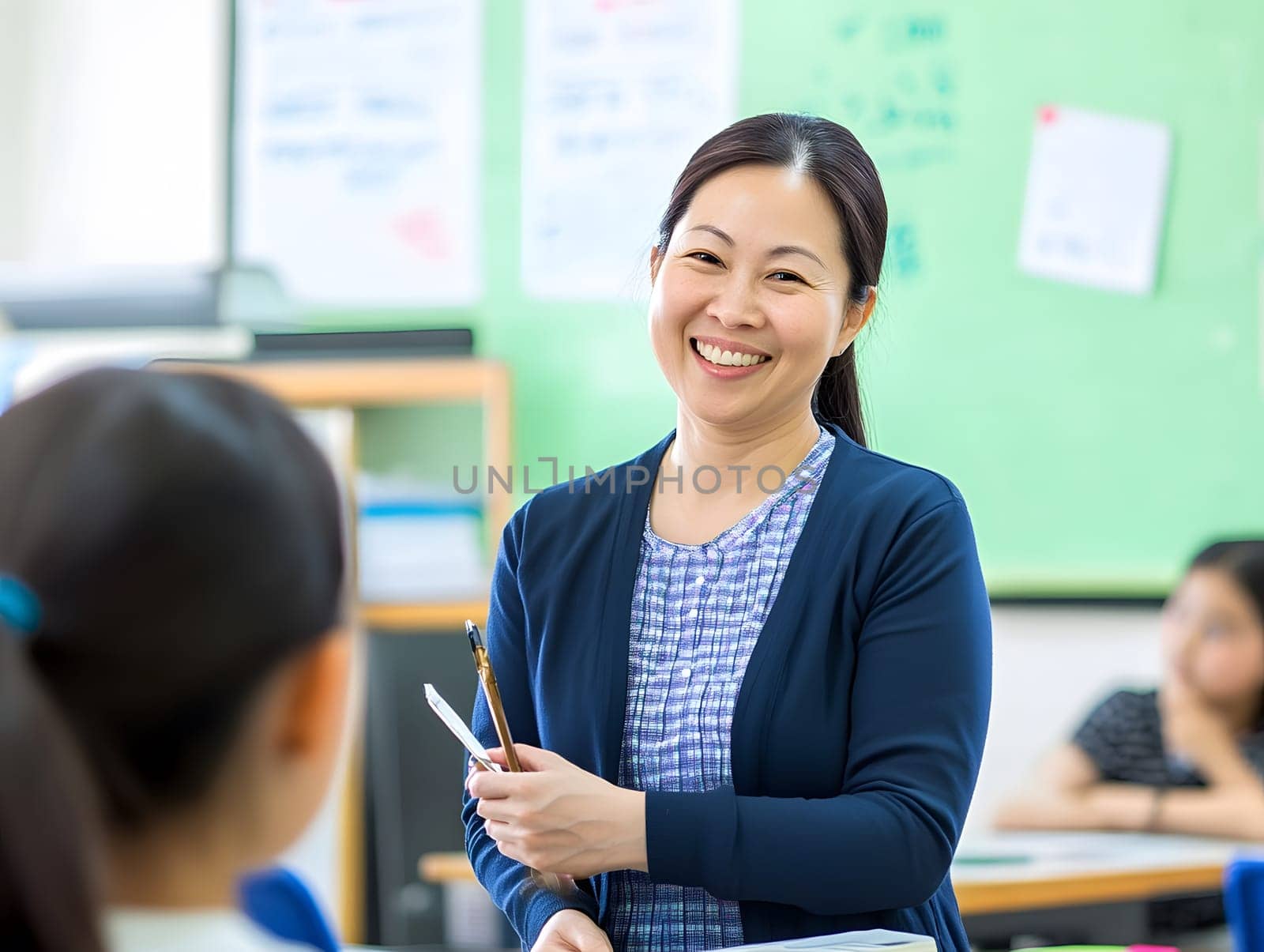Female Asian Teacher educates children in the Class School
