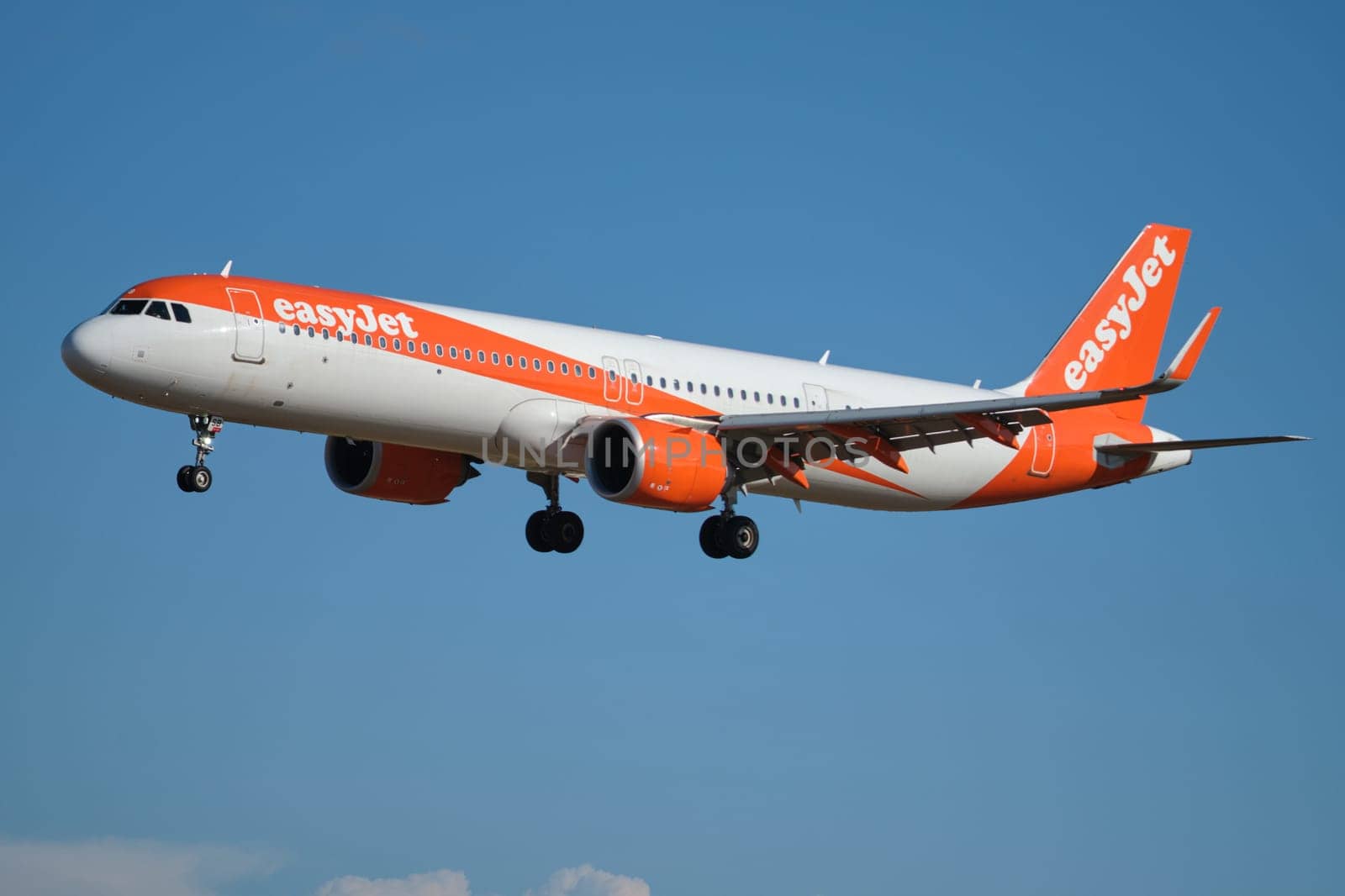 Lisbon, Portugal - September 2, 2023: easyJet Airbus A320-214 passenger plane descends to land in Humberto Delgado Airport in Lisbon