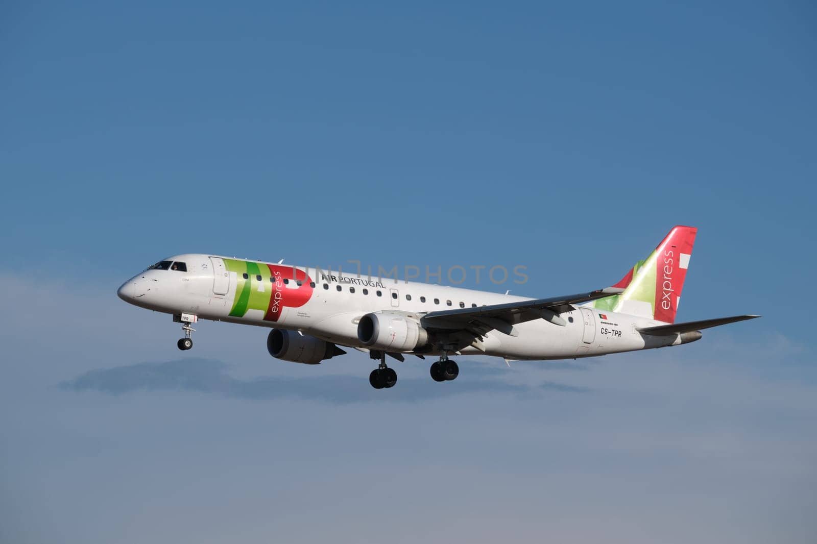 Lisbon, Portugal - September 02, 2023: TAP Express Embraer E190LR passenger plane landing in Humberto Delgado Airport in Lisbon