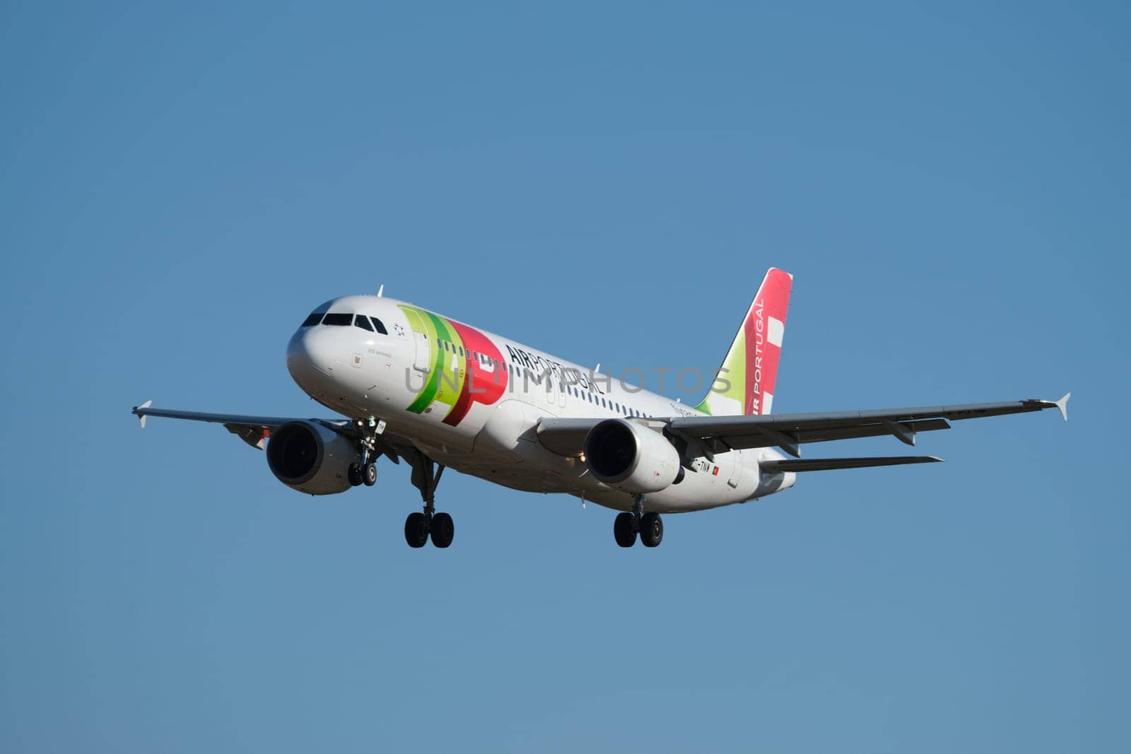 Lisbon, Portugal - September 2, 2023: TAP Portugal Airbus A320-214 passenger plane descend to land in Humberto Delgado Airport in Lisbon