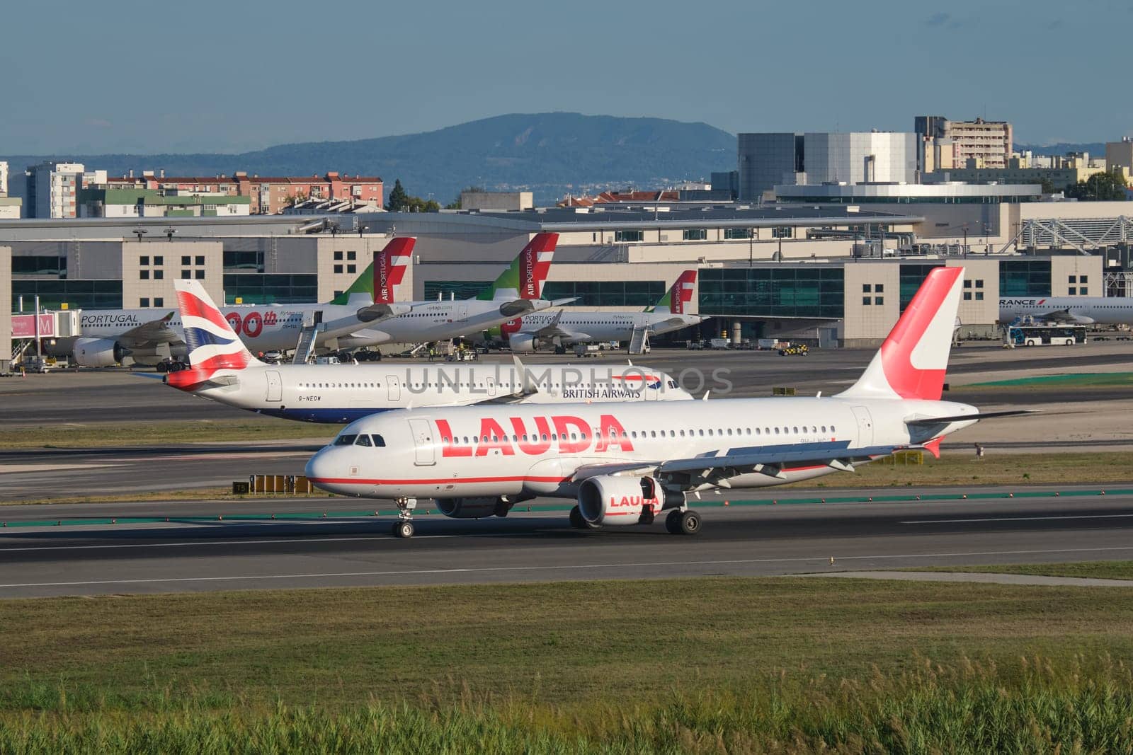 Lisbon, Portugal - September 2, 2023: Lauda Europe Airbus A320-214 passenger plane taxi on runway in Humberto Delgado Airport in Lisbon