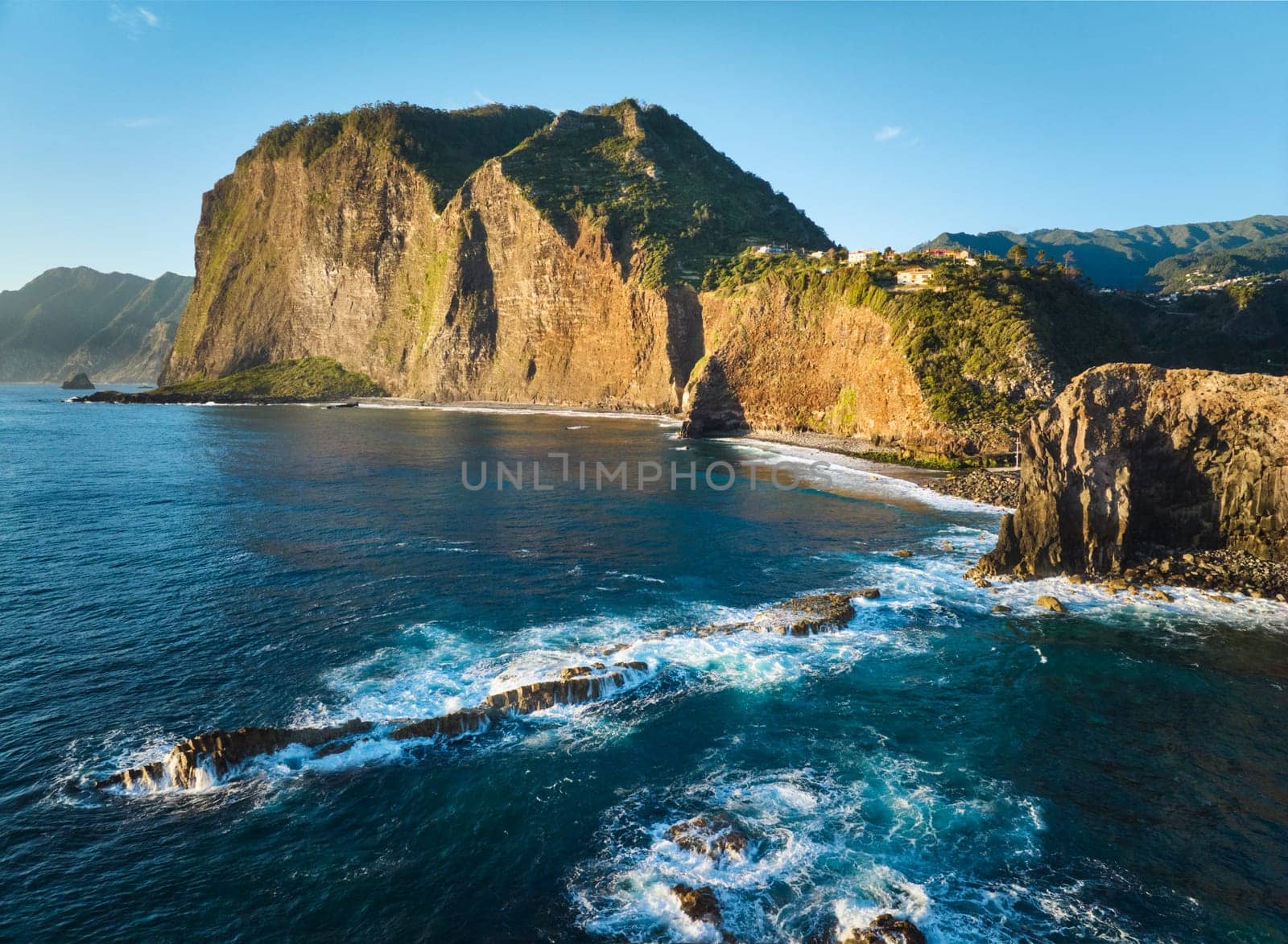 Aerial view of Madeira cliffs coastline landscape on sunrise, Guindaste viewpoint, Madeira island, Portugal