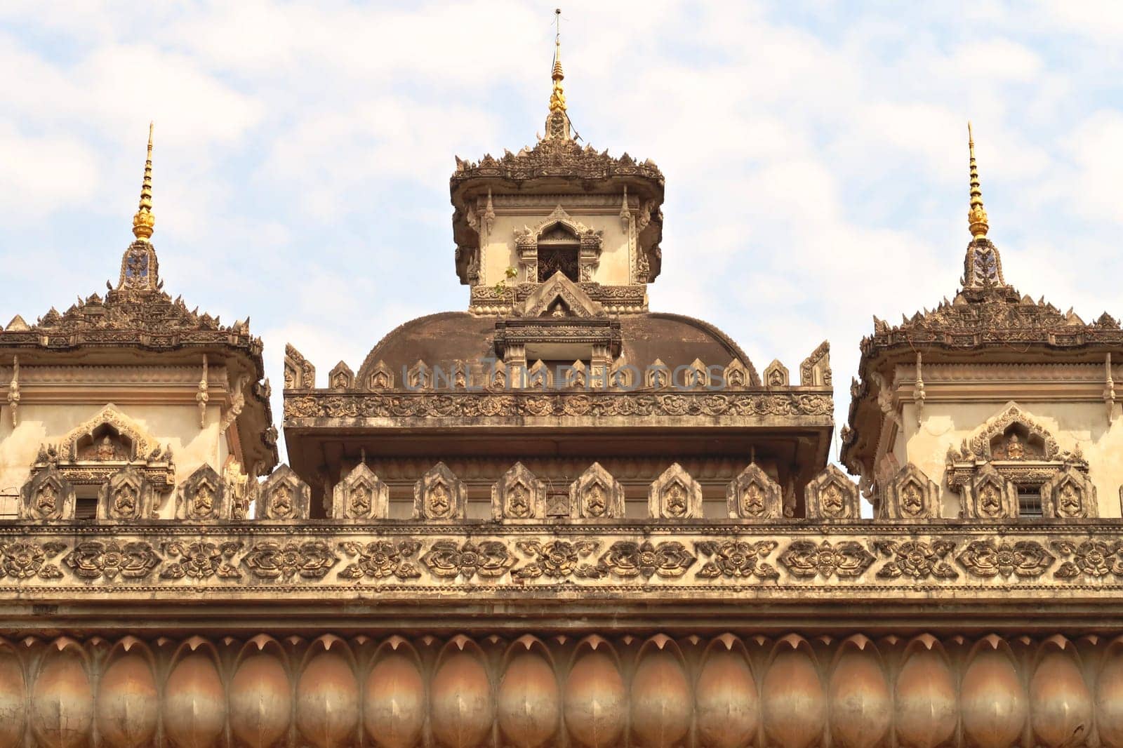 The elaborate roof and turrets, towers of the Patuxai Monument, decorated with a lot of stucco in different patterns and shapes, Vientiane, Laos 2023