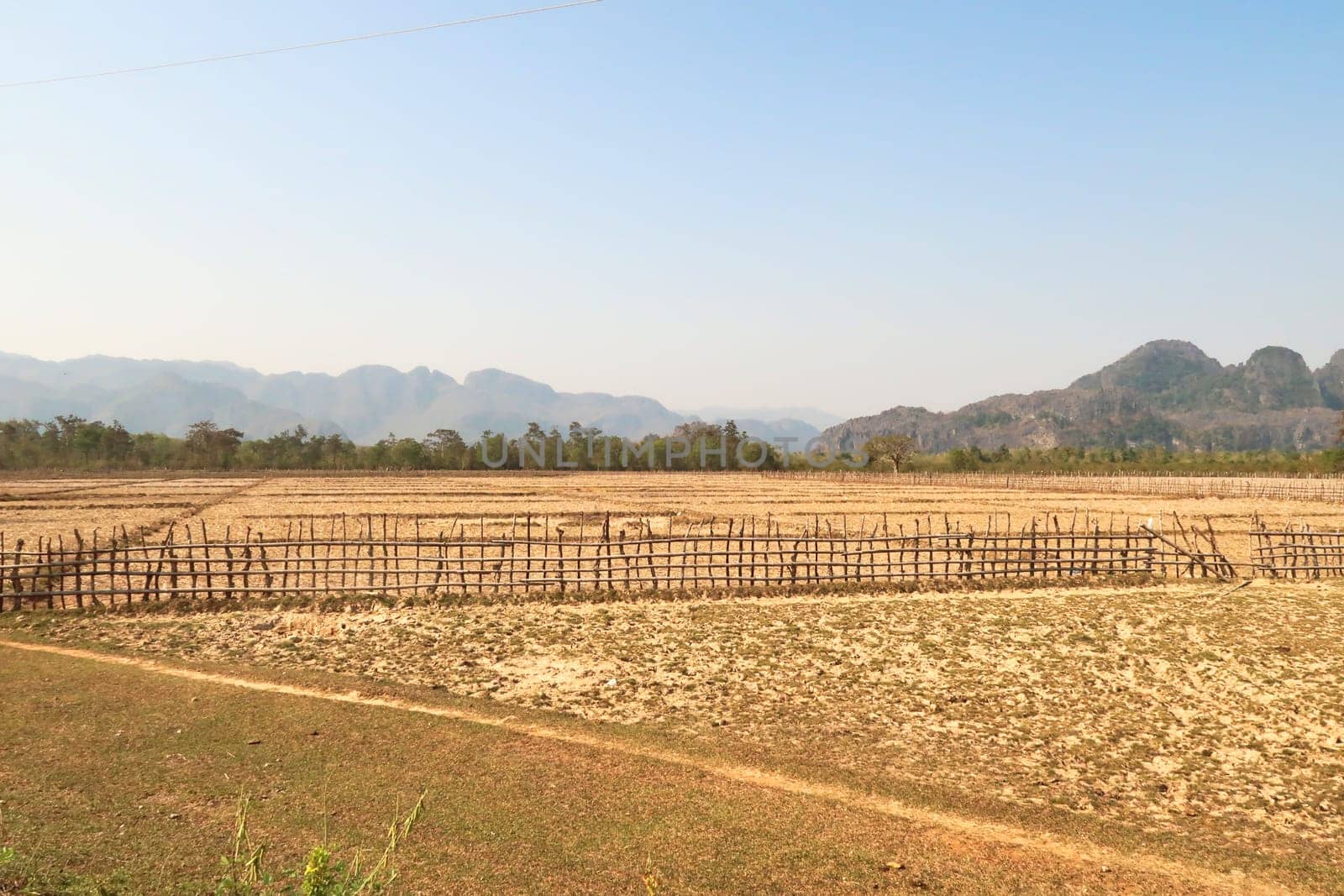 View onto some dried out farmland in dry season on the Thakhek Motorbike Loop, Laos 2023