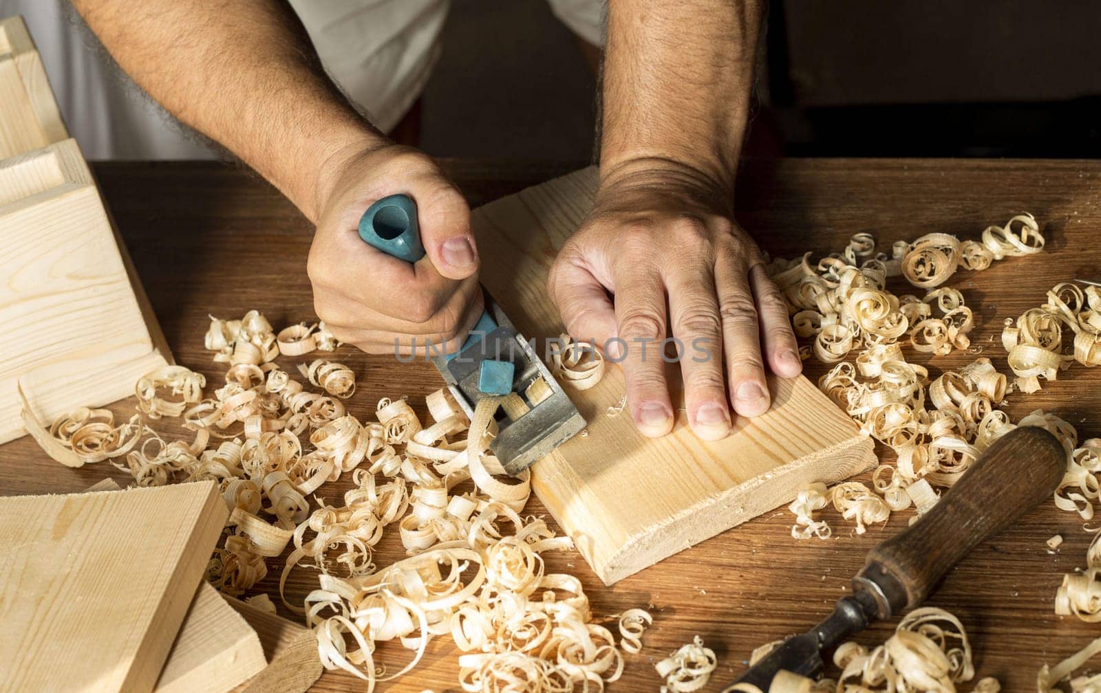carpenter working with his bare hands wood. High resolution photo