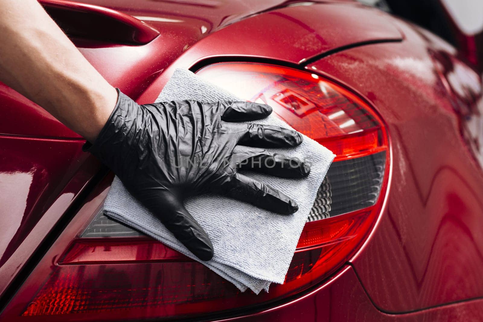 close up person cleaning car exterior. High resolution photo
