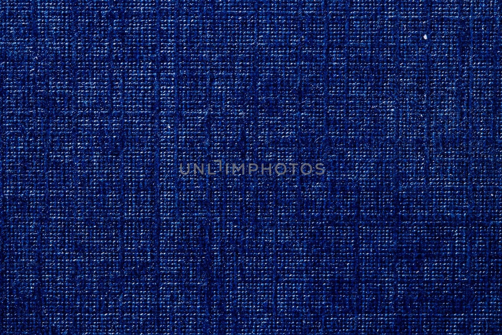 Seamless Cardboard box texture background. Close-up of a detail from a dark blue surface of a gift box. Beautiful backdrop. Macro.