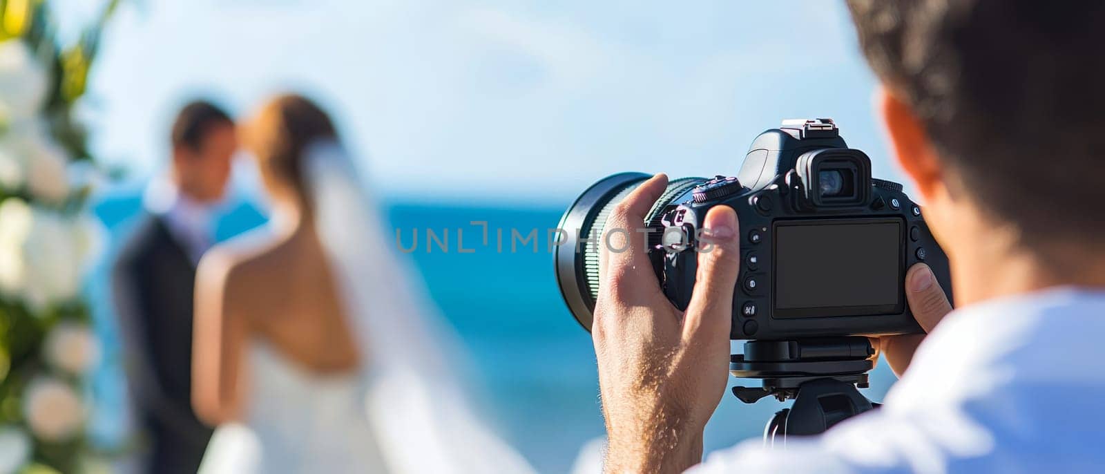Wedding photographer focuses on capturing a special moment between a bride and groom by the sea.
