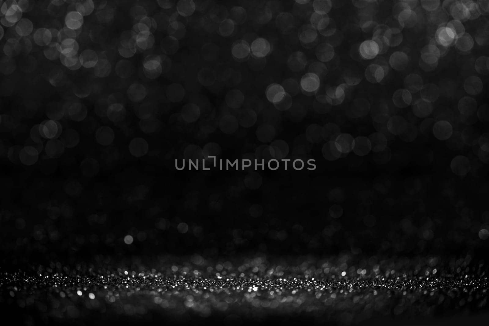 Black friday bokeh background. Elegant dark blur layout design. Silver and black glitter place on table with spotlight. Luxury abstract banner with copyspace.