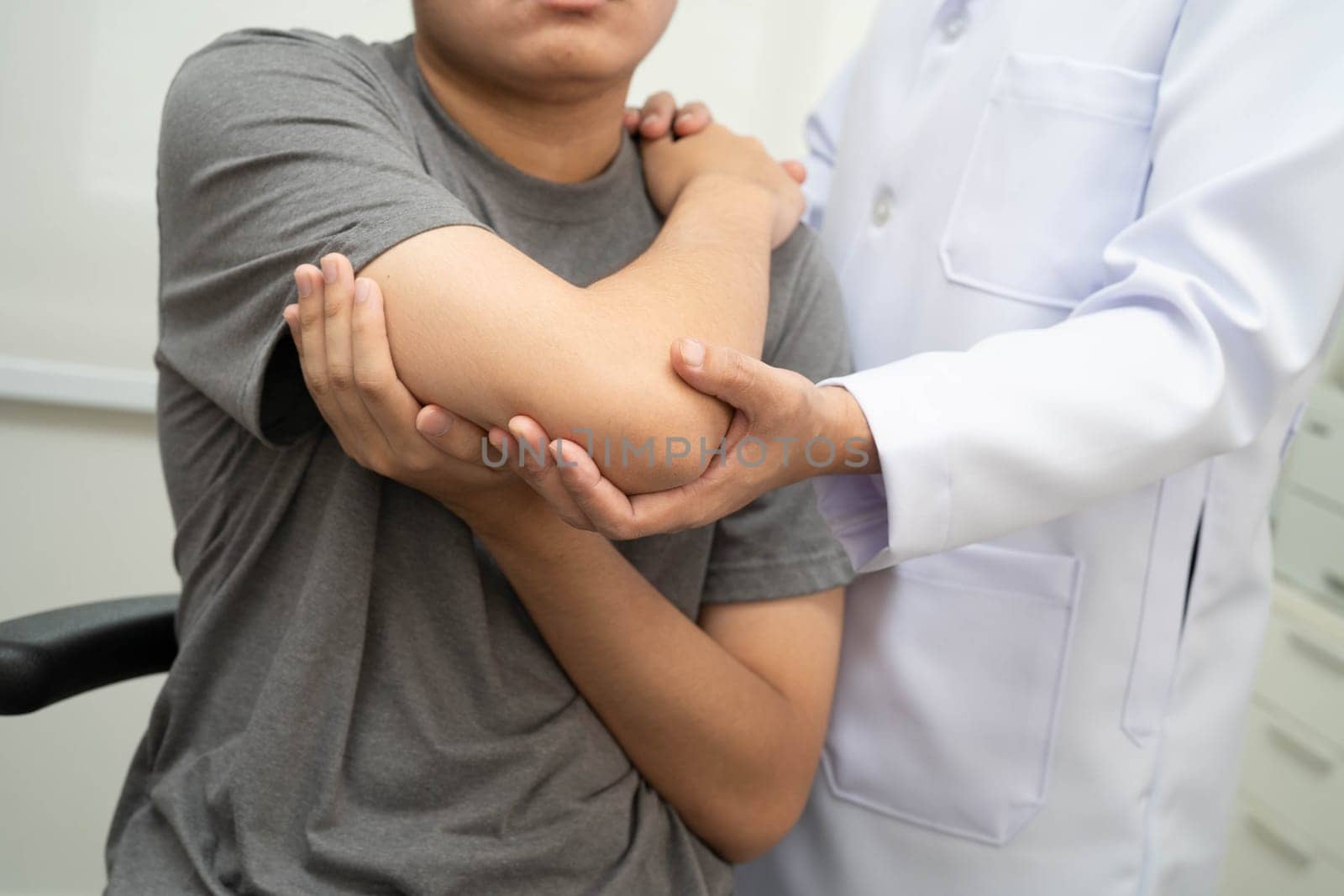 Physical therapy, Asian therapist doctor treat perform pain young man in hospital.
